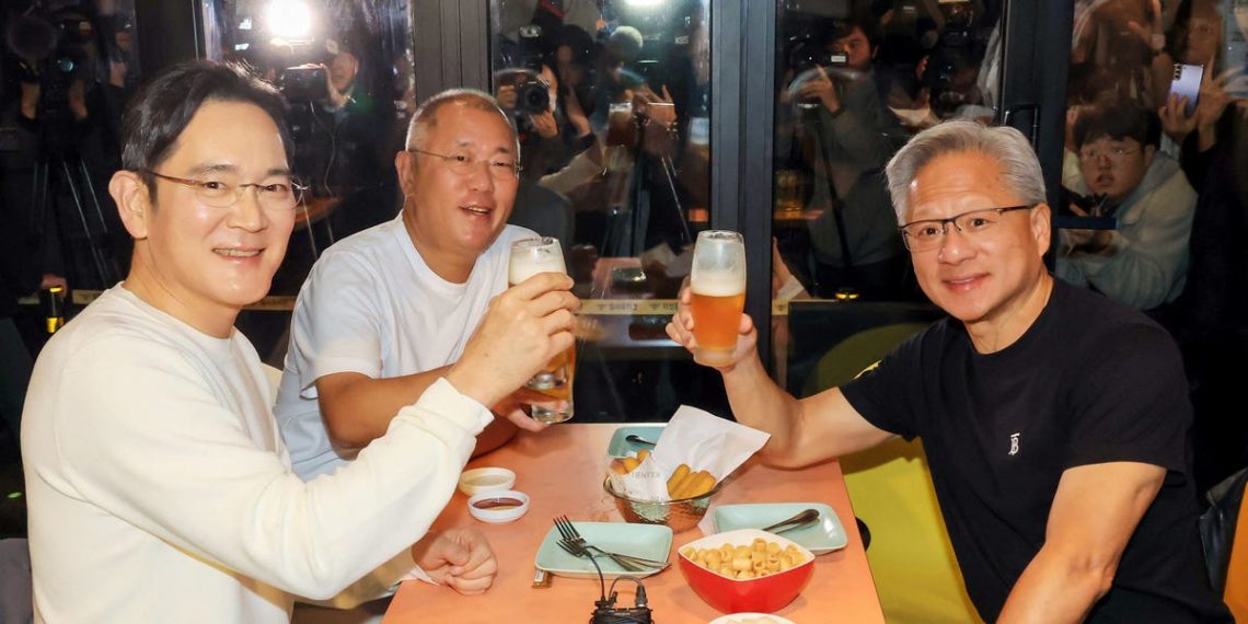 A detail in this photo of Jensen Huang having fried chicken with the heads of Samsung and Hyundai shows the extent of his tech celebrity