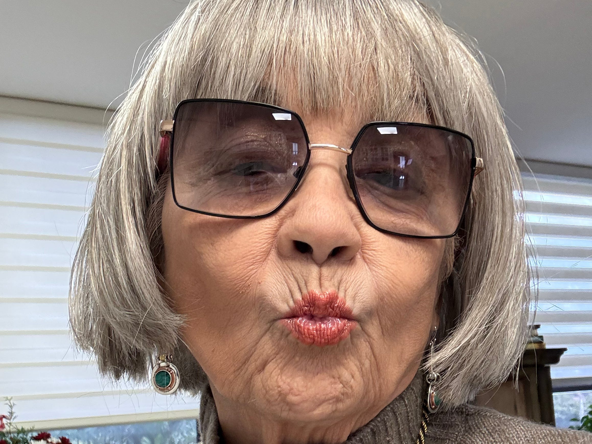 An older woman puckering up her lips