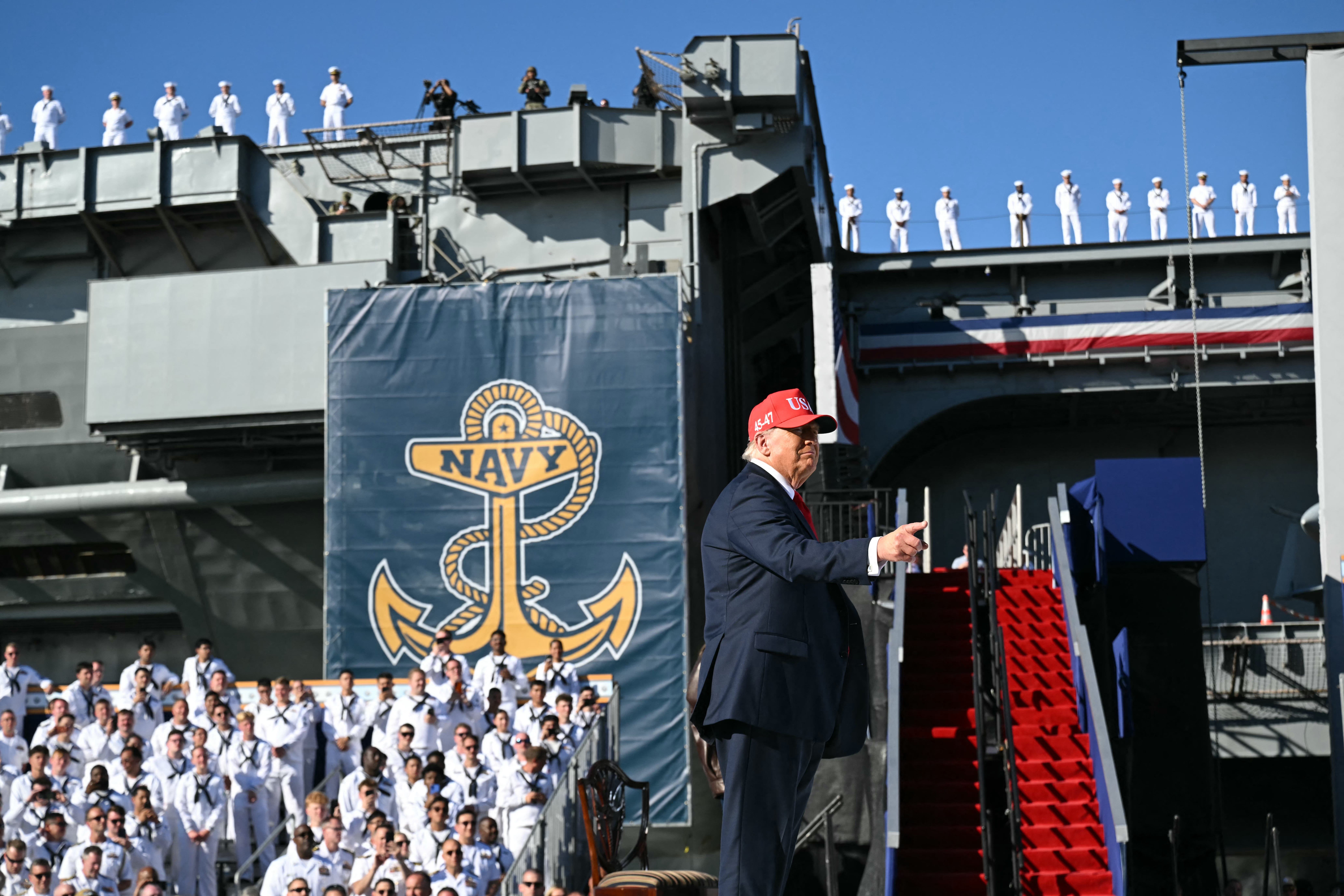 US President Donald Trump gestures during a visit to the USS Harry S. Truman during the US Navy's 250th anniversary celebration,