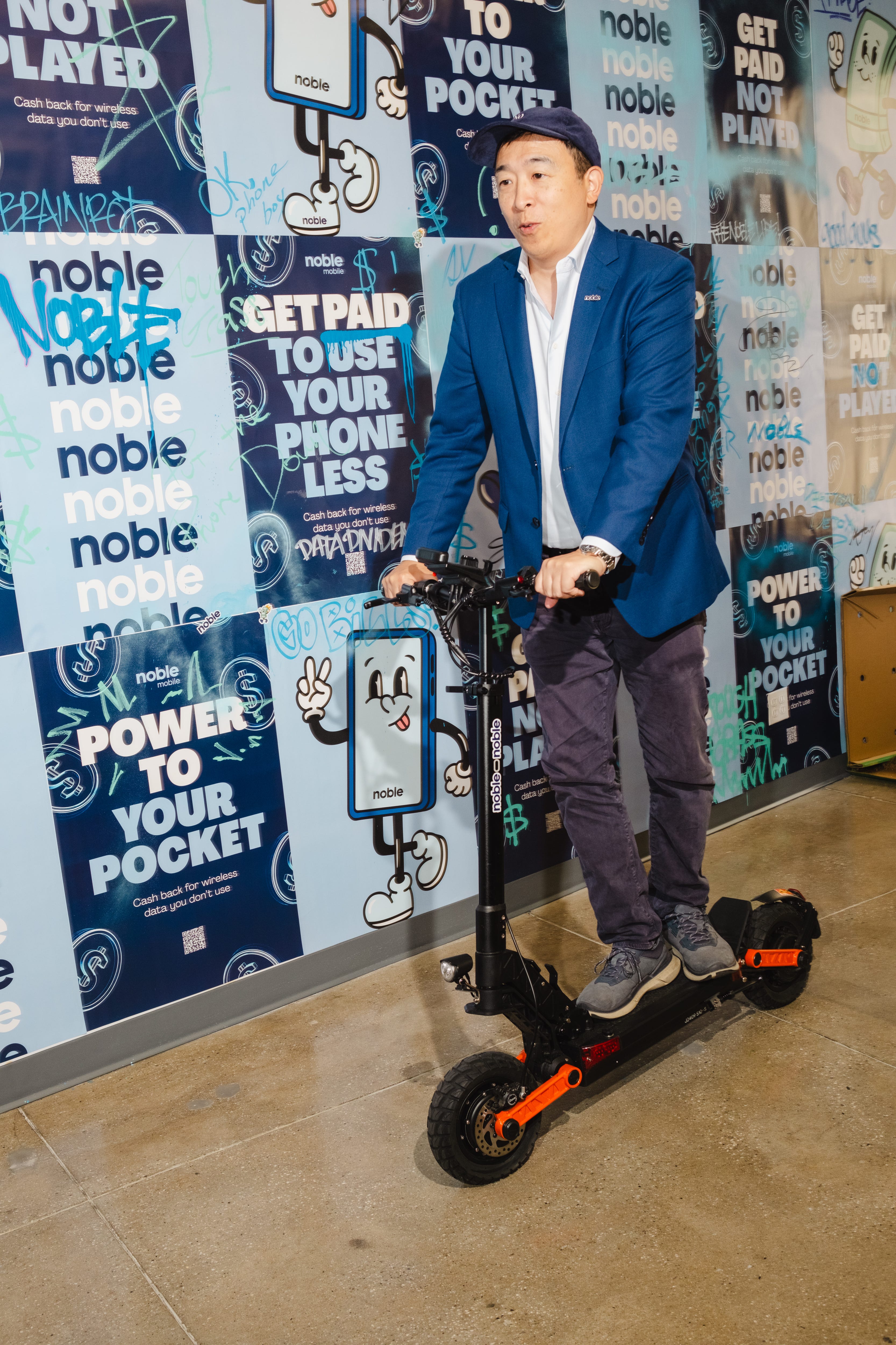 Andrew Yang on his electric scooter