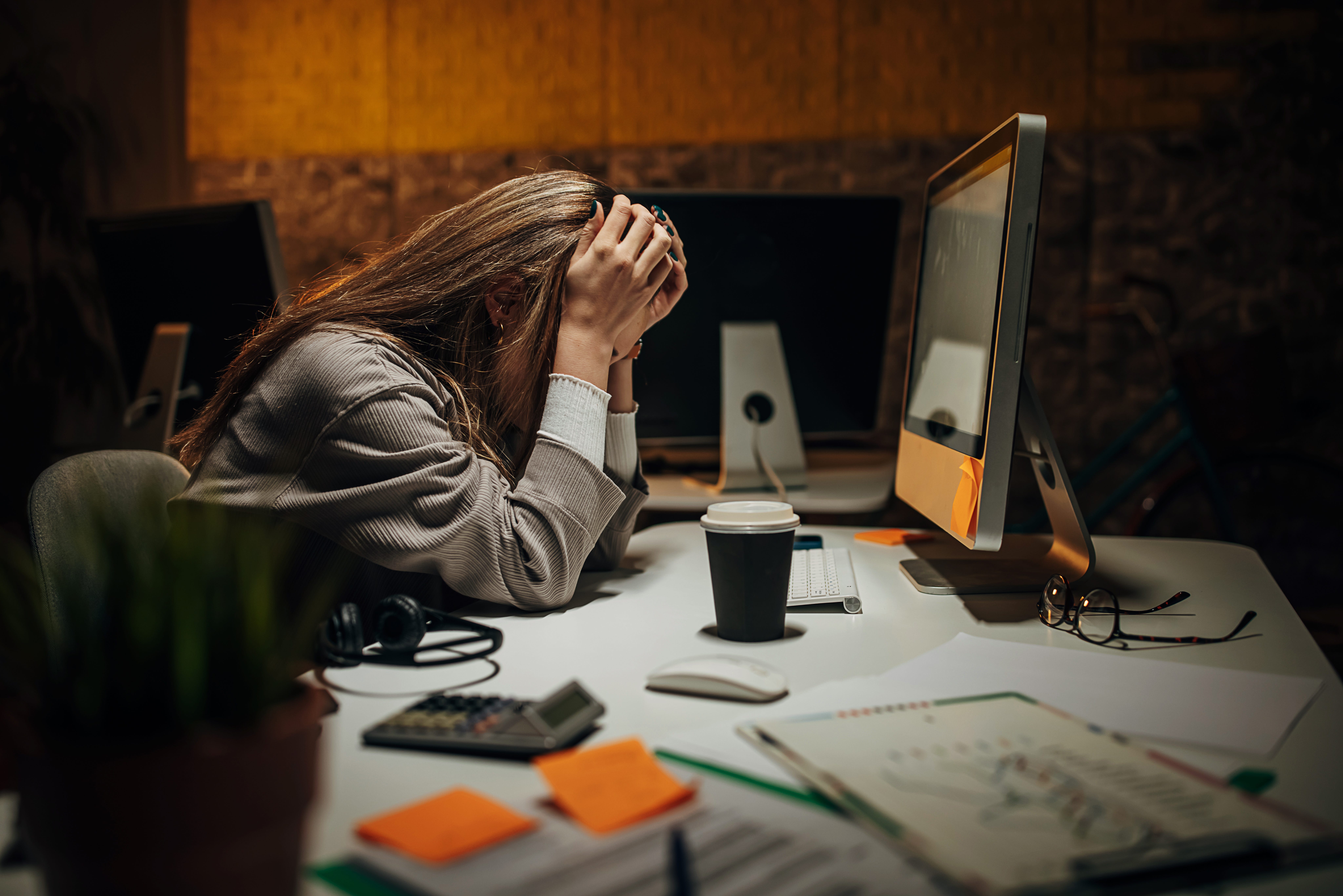 a woman frustrated at her work desk