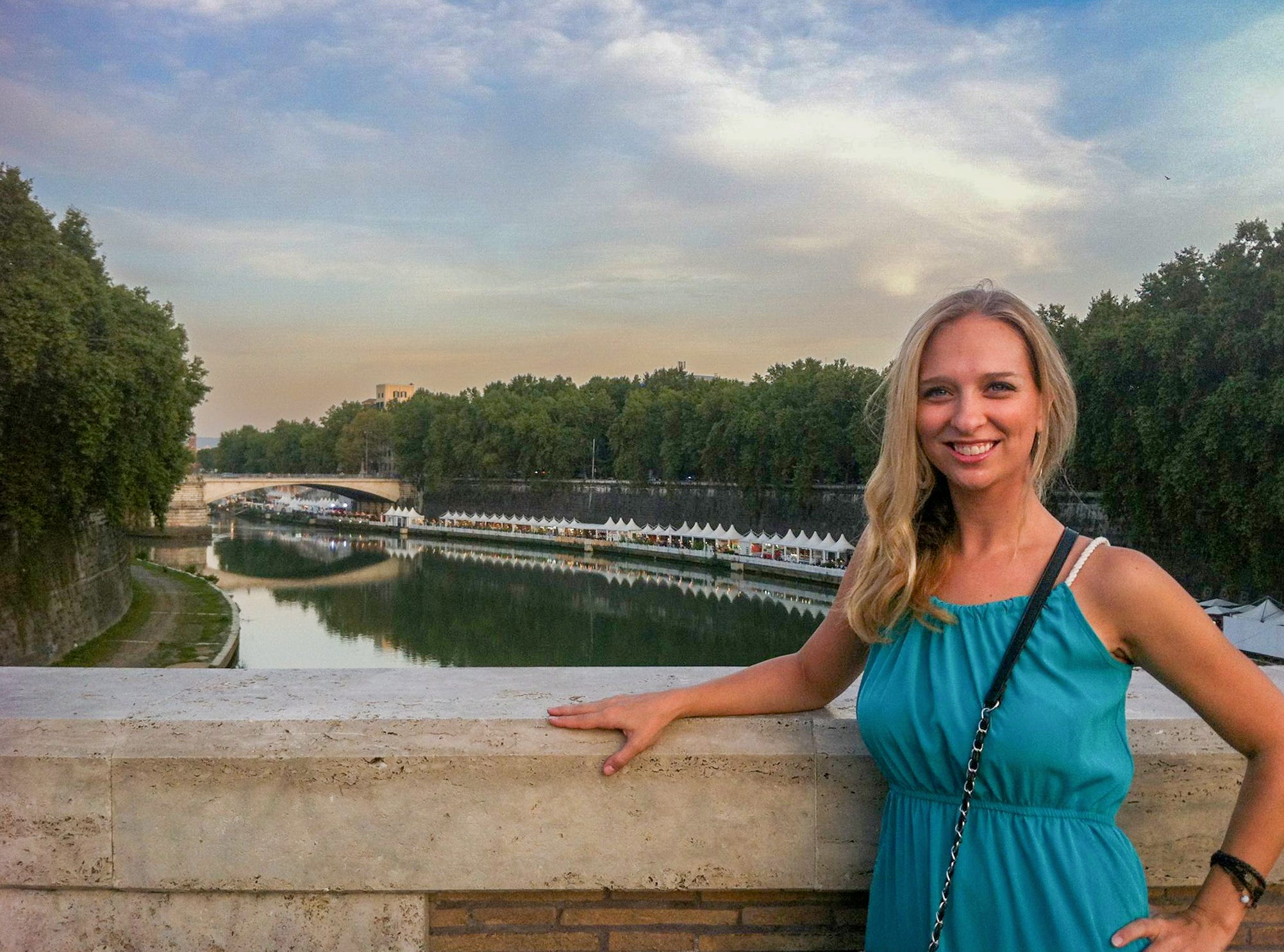Author Jen Belcher leaning on bridge, smiling