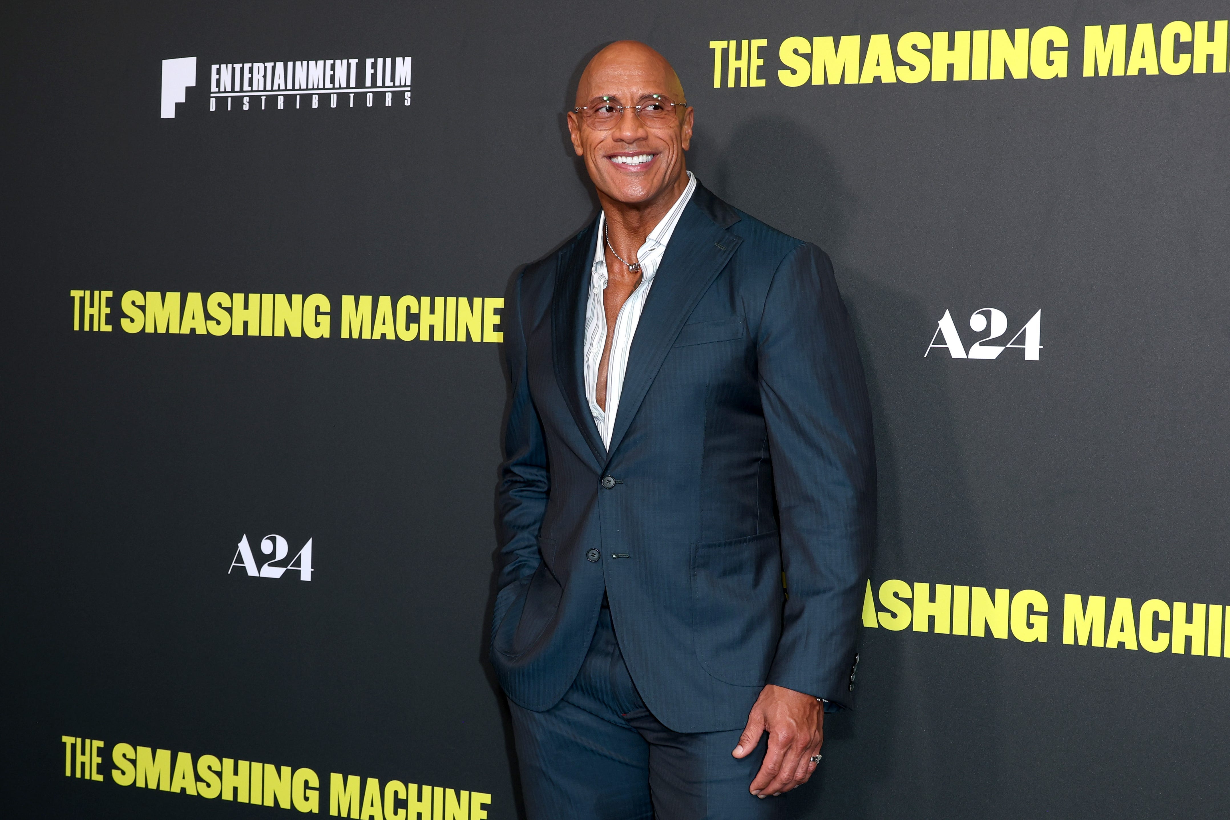 Dwayne Johnson in a suit smiling