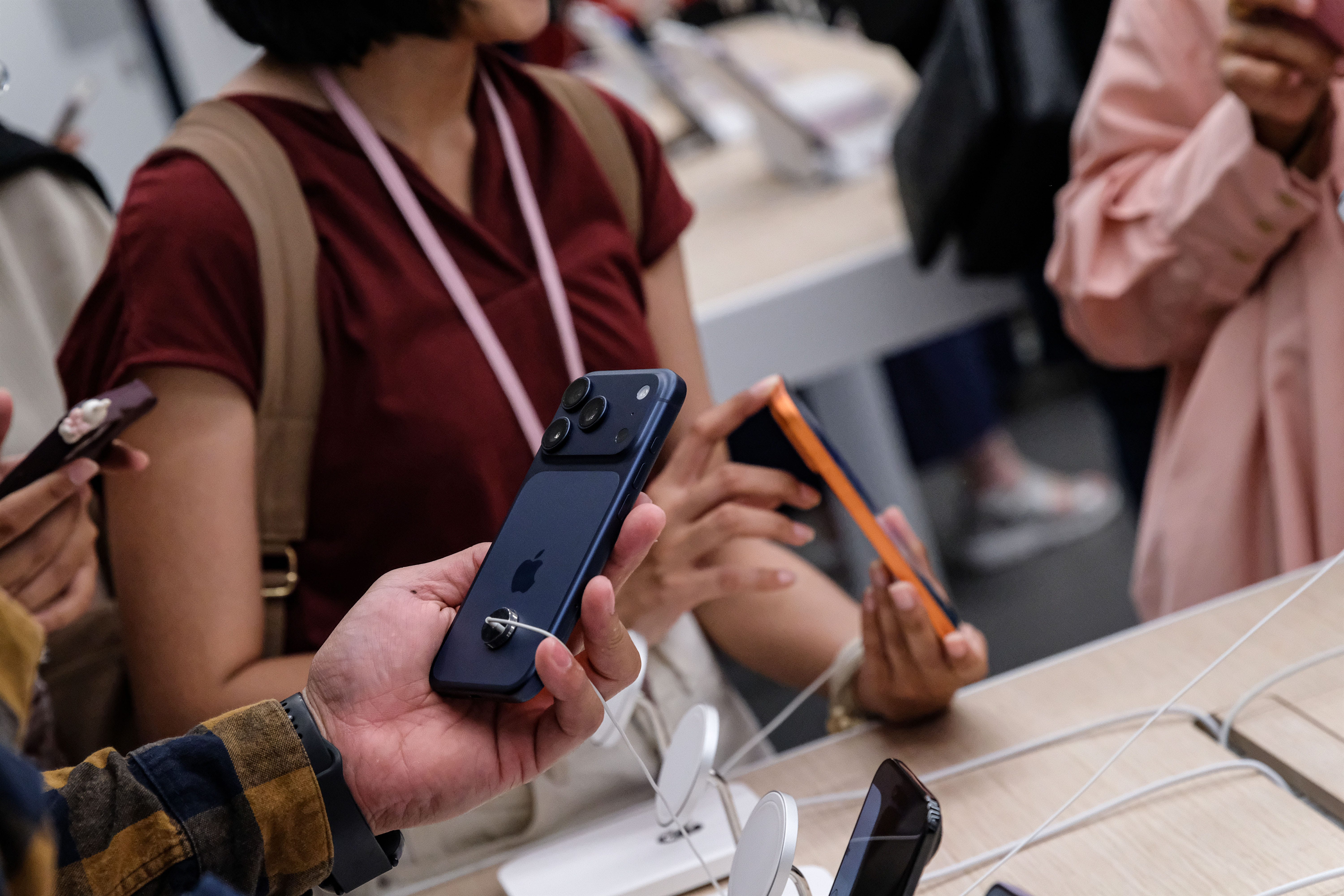 hands holding iPhone 17 Pro models