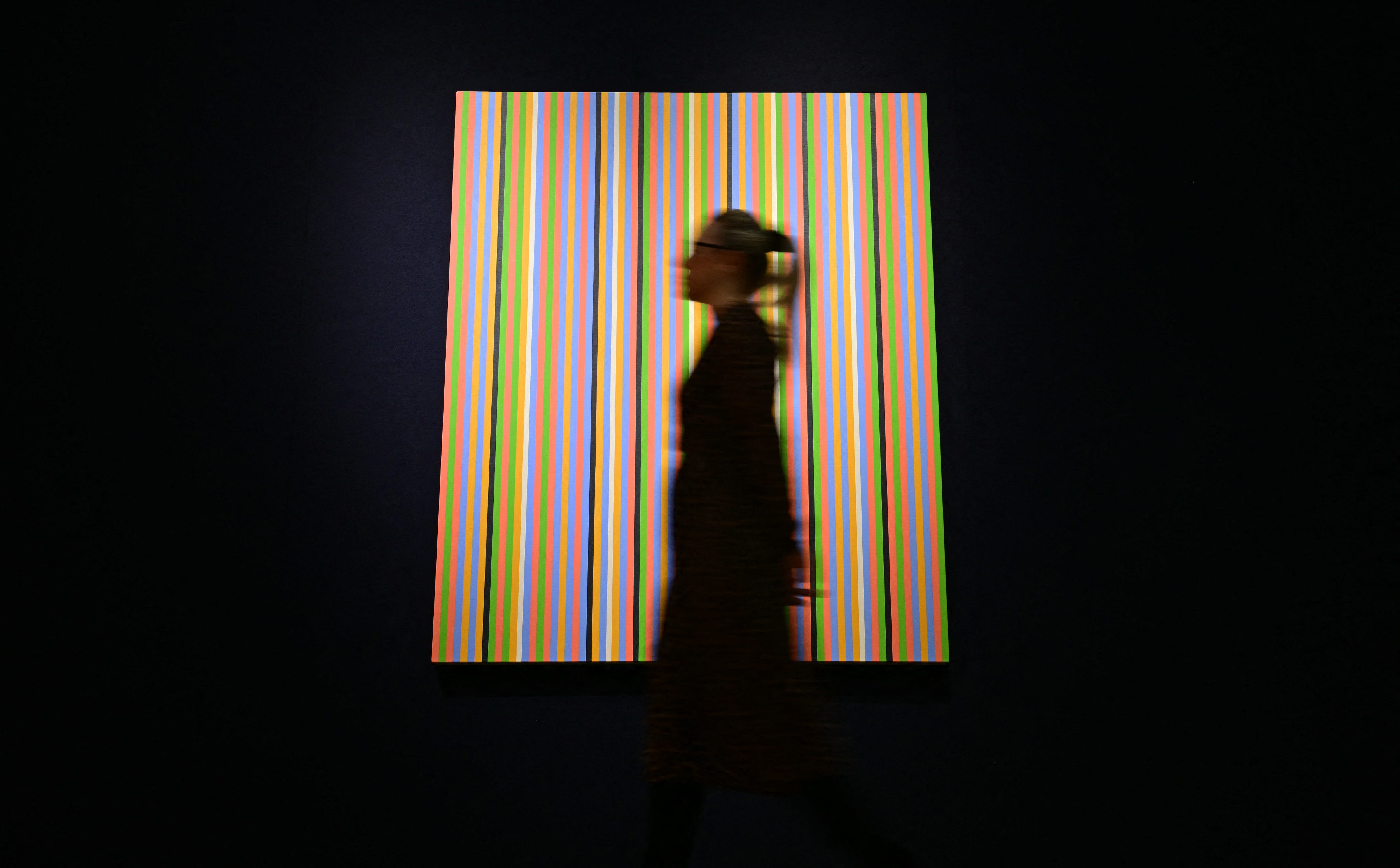 Woman in front of art at Christie's auction