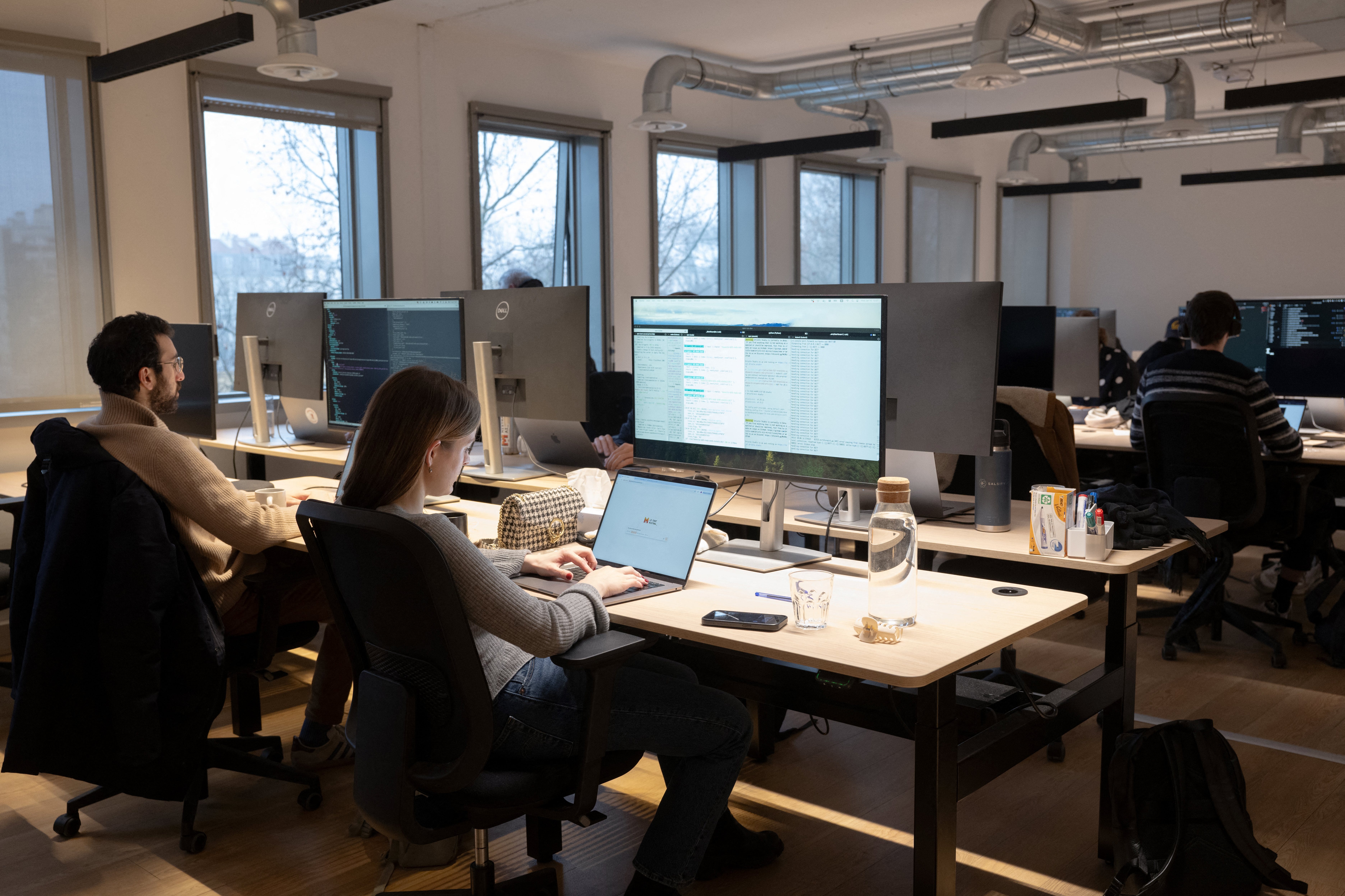 Employees work at the Mistral AI headquarters, an artificial intelligence startup, in Paris, on January 15, 2025