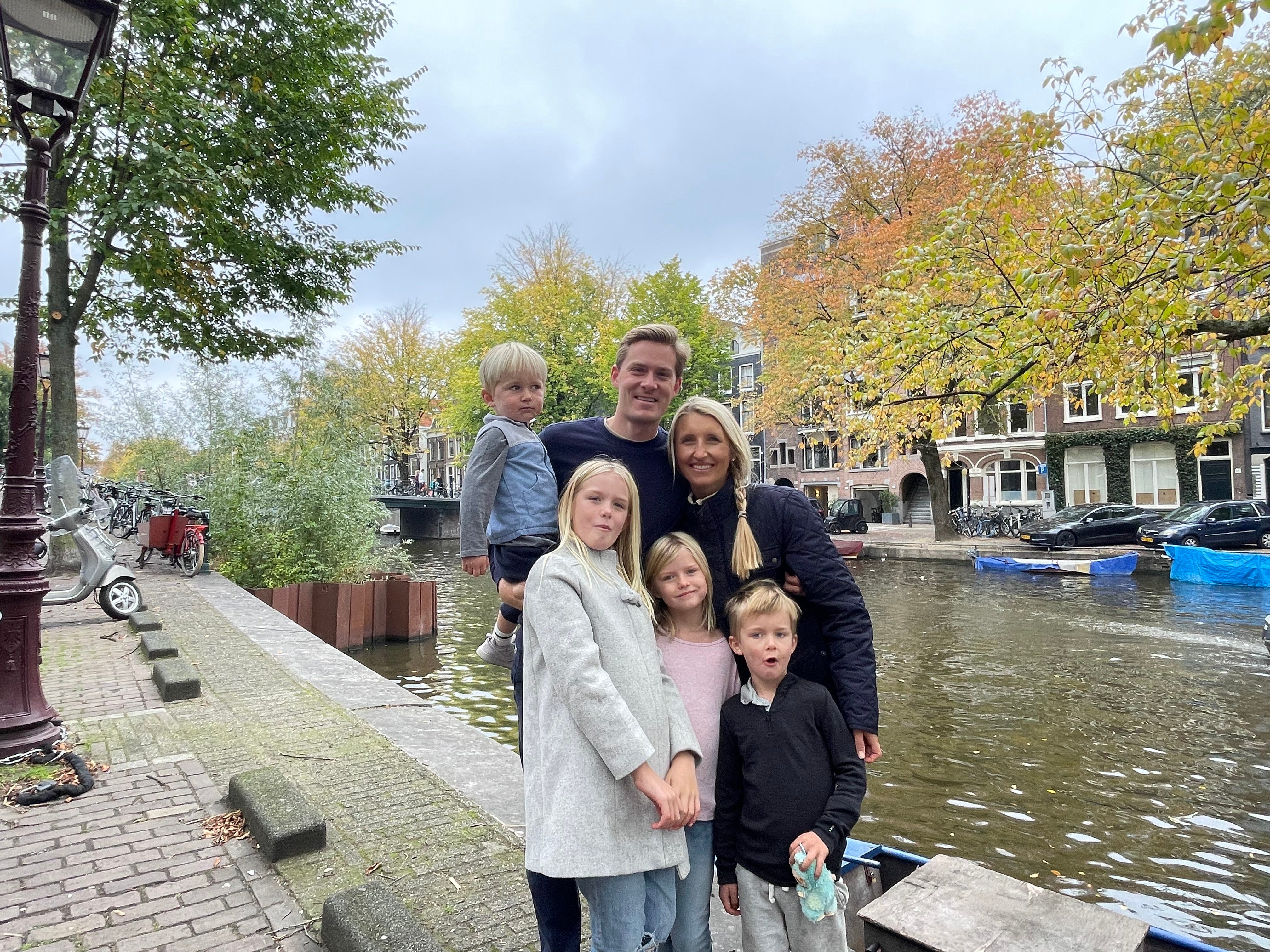 Family posing for photo while traveling
