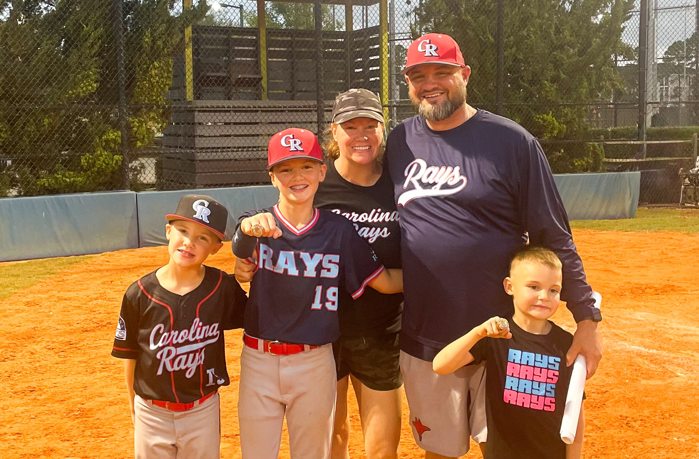 The author poses with her family on a baseball field.