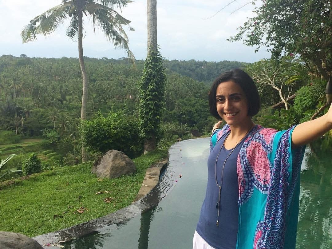 Carey Bentley posing near rice fields in Bali.