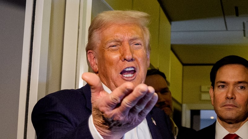 President Donald Trump, accompanied by U.S. Secretary of State Marco Rubio (R) and U.S. Treasury Secretary Scott Bessent (L), speaks to members of the media aboard Air Force One on October 27, 2025, in flight. Trump is in route to Japan after attending the Association of Southeast Asian Nations (ASEAN) summit in Malaysia,