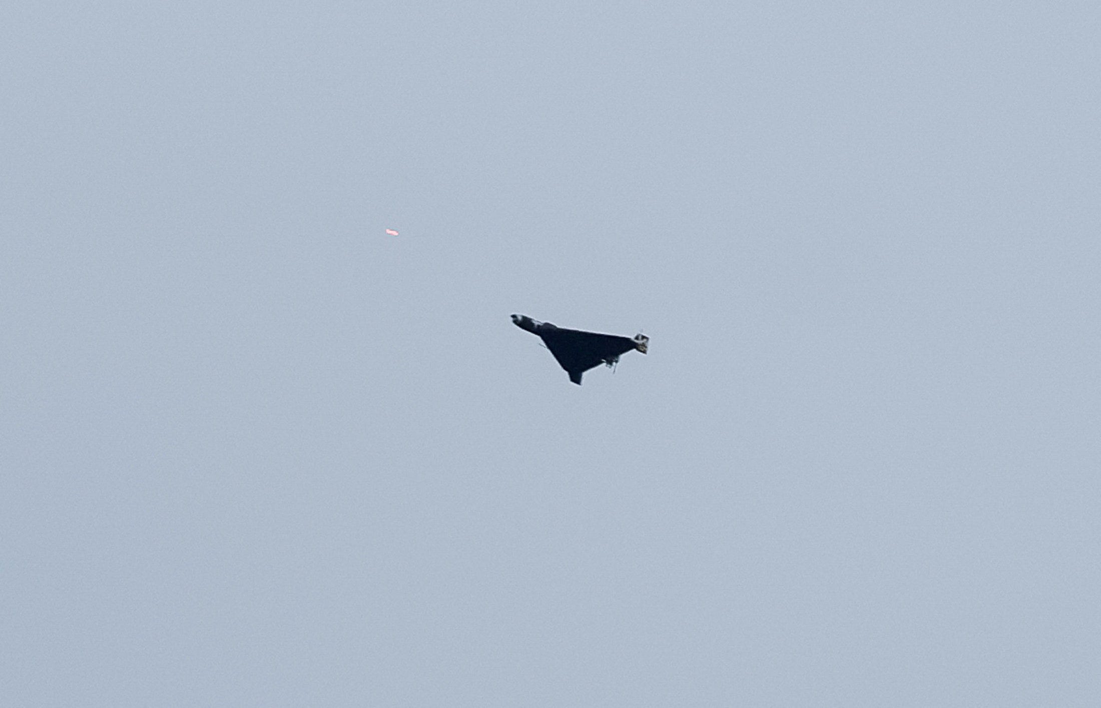 FILE PHOTO: A Russian drone flies over the city as Ukrainian servicemen fire towards it during Russian drone and missile strikes, amid Russia's attack on Ukraine, in Kyiv, Ukraine September 28, 2025.