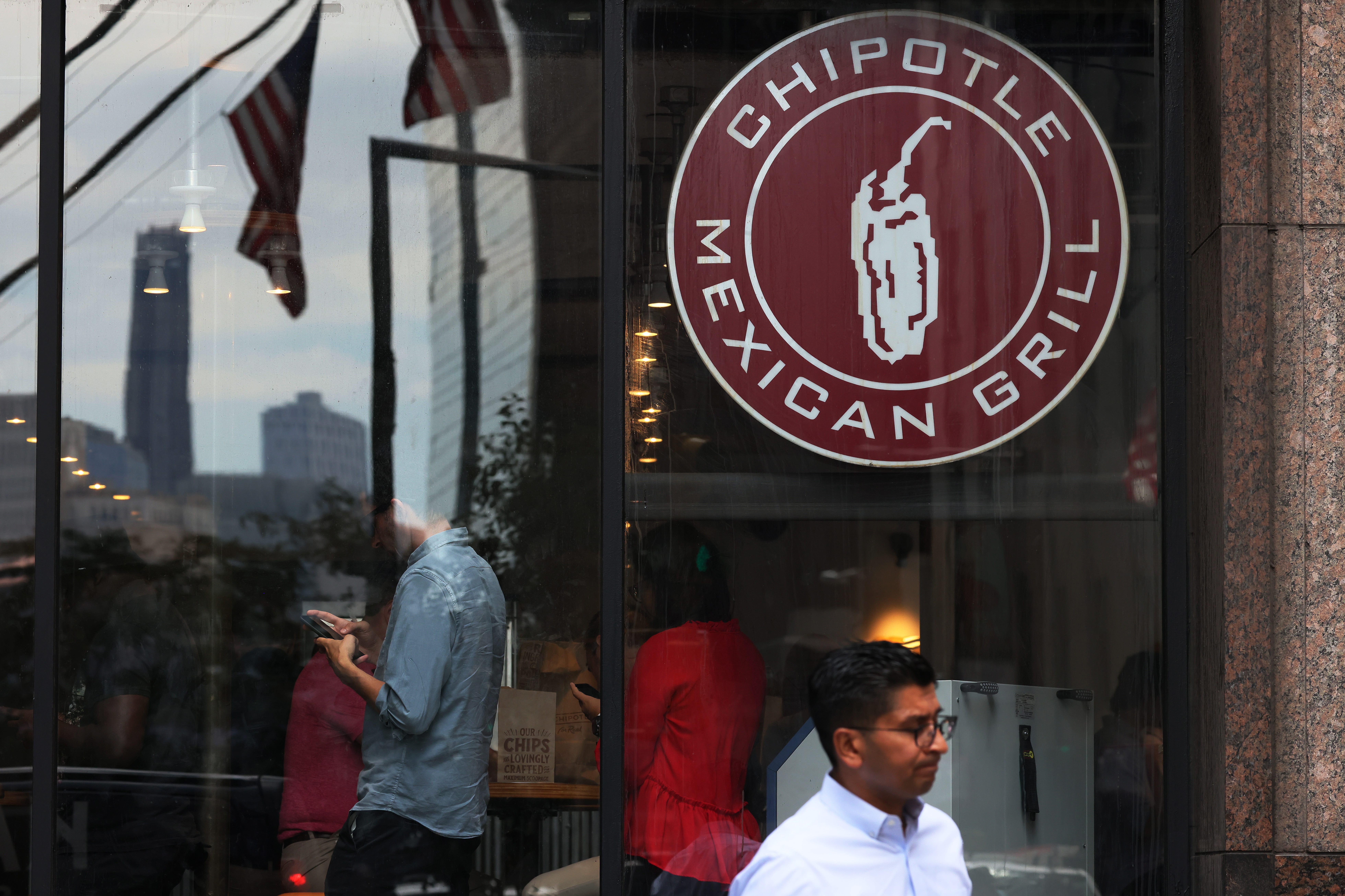 People walk past a Chipotle store on August 10, 2022 in New York City.