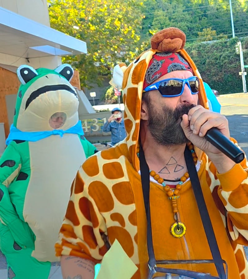 Robby Roadsteamer protesting with the frog outside the Portland ICE facility, where he was shot by officers.