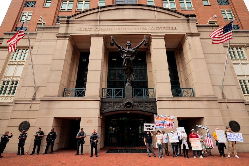 ALEXANDRIA, VIRGINIA - OCTOBER 08: Activists protest outside the U.S. District Court for the Eastern District of Virginia's Bryan Courthouse during the arraignment of former FBI Director James Comey on October 08, 2025 in Alexandria, Virginia. Comey pleaded not guilty during his arraignment today after being indicted by a Virginia grand jury on charges of making a false statement and obstruction during congressional testimony in 2020. (Photo by Chip Somodevilla/Getty Images)