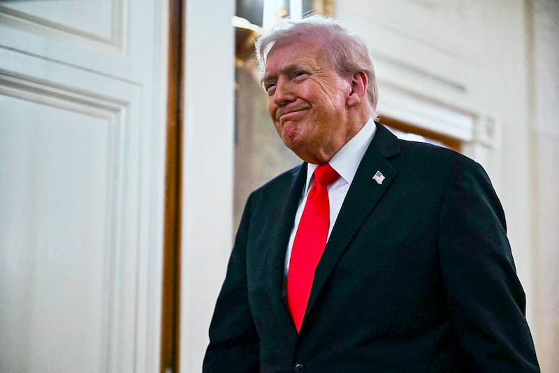 US President Donald Trump walks toward the East Room of the White House for a ballroom dinner in Washington, DC, on October 15, 2025. Trump, who is remodeling the White House to his tastes, will build a massive ballroom for hosting official receptions, one of the largest projects at the US executive mansion in over a century. (Photo by ANDREW CABALLERO-REYNOLDS / AFP)