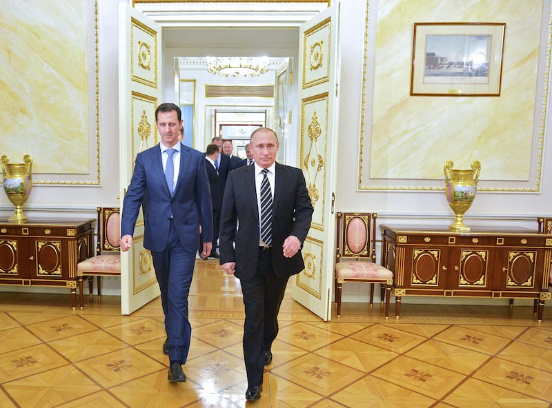 Russian President Vladimir Putin (R) greets his Syrian counterpart Bashar al-Assad upon his arrival for a meeting at the Kremlin in Moscow on October 20, 2015. Assad, on his first foreign visit since Syria's war broke out, told his main backer and counterpart Putin in Moscow that Russia's campaign in Syria has helped contain 