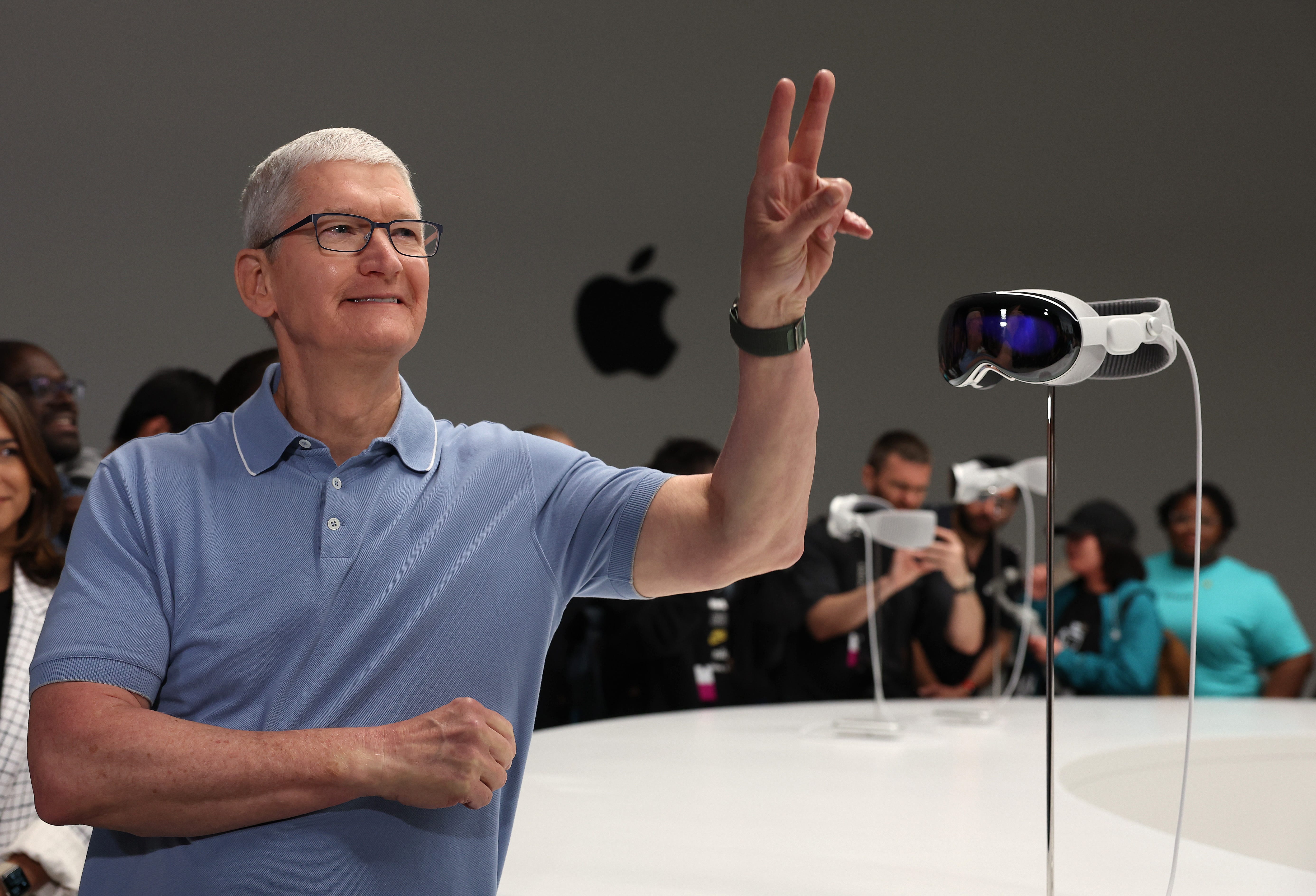 Apple CEO Tim Cook stands next to an Apple Vision Pro headset, June 2023