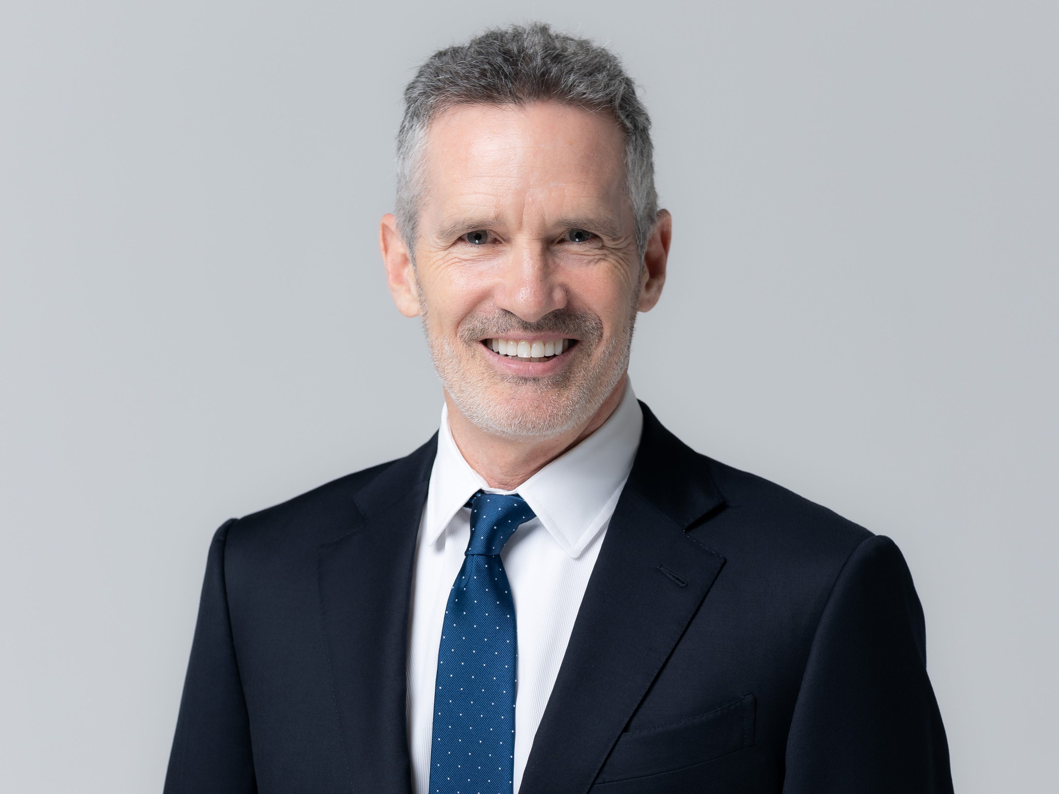Dan Springer is wearing a blue tie and a suit.