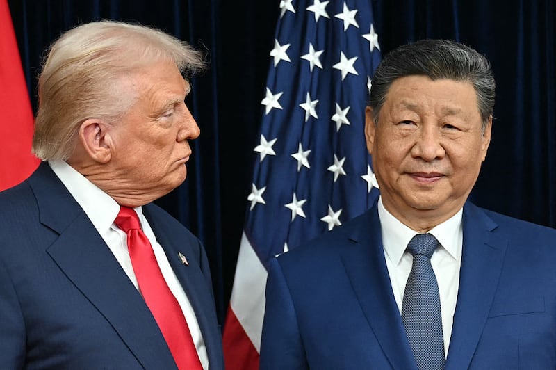 US President Donald Trump (L) and China's President Xi Jinping arrive for talks at the Gimhae Air Base, located next to the Gimhae International Airport in Busan on October 30, 2025.