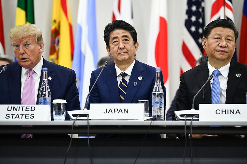 US President Donald Trump, Japan's Prime Minister Shinzo Abe and China's President Xi Jinping attend a meeting at the G20 Summit in Osaka on June 28, 2019.