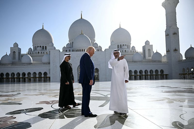 Yousif al-Obaidli, (R) the director-general of the Sheikh Zayed Grand Mosque, accompanies US President Donald Trump on a tour of the mosque in Abu Dhabi on May 15, 2025. The United Arab Emirates is the third leg of Trump's visit to the region, which has already taken him to Saudi Arabia and Qatar.