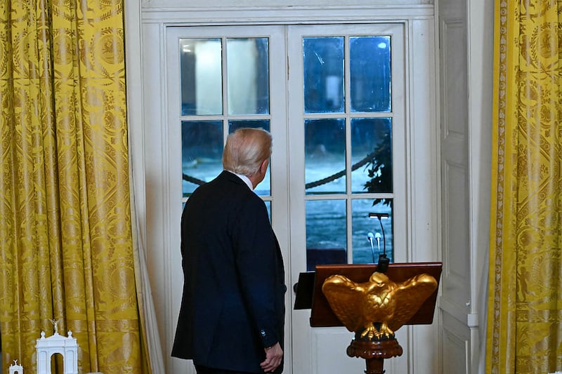 US President Donald Trump looks toward the construction site of a ballroom as he speaks during a dinner with donors in the East Room of the White House in Washington, DC on October 15, 2025. US President Donald Trump, who is remodeling the White House to his tastes, will build a massive ballroom for hosting official receptions, one of the largest projects at the US executive mansion in over a century.