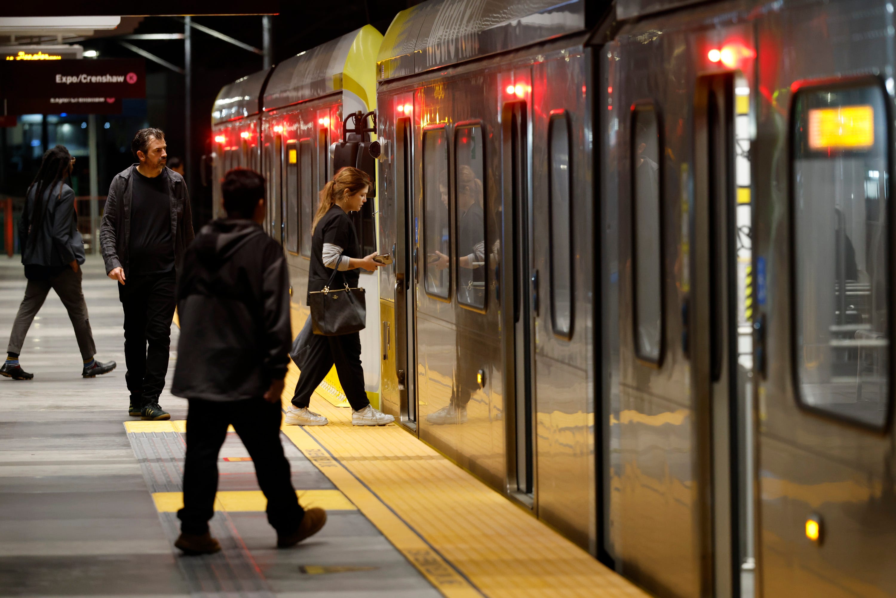 Commuters board a train in Los Angeles