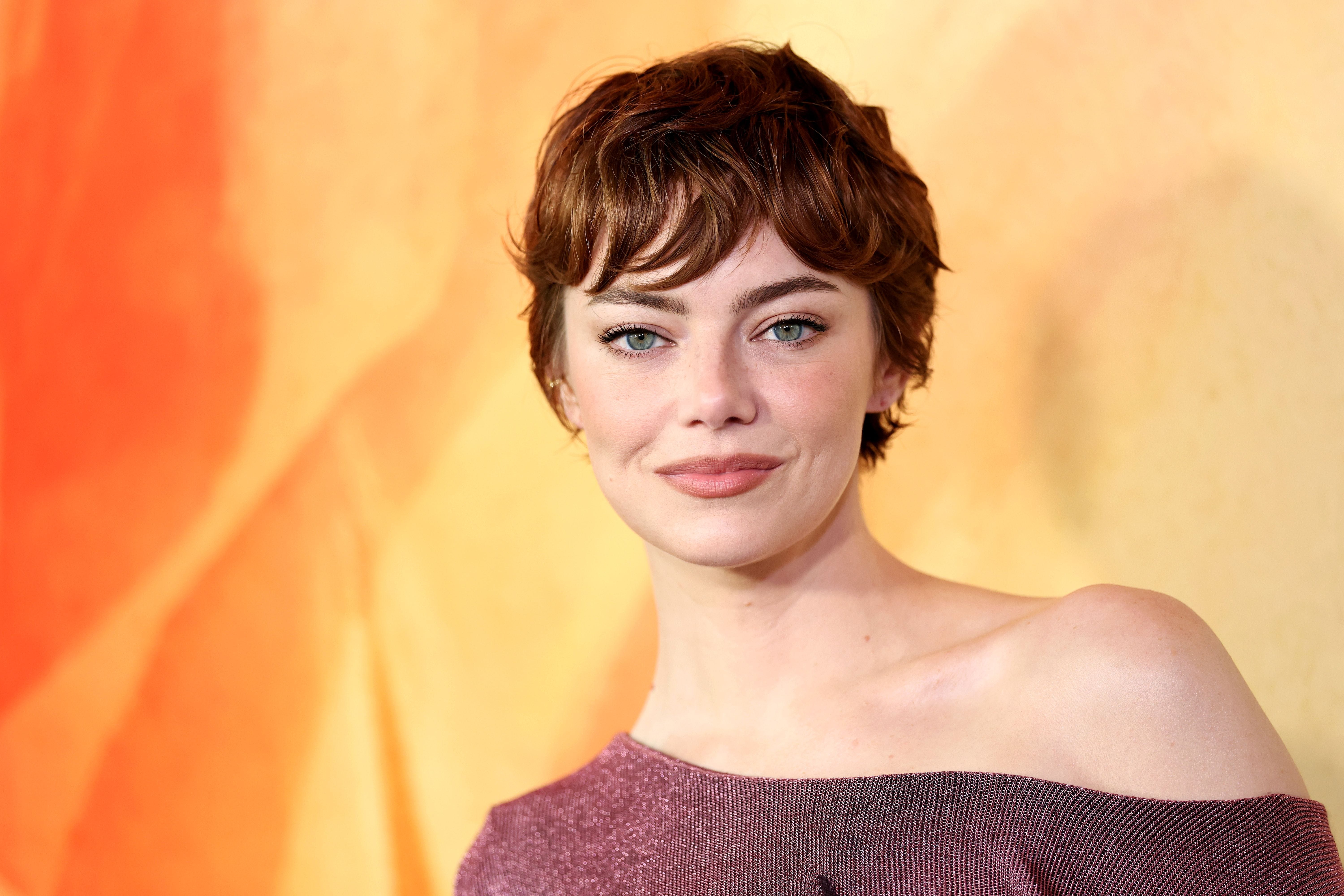 Emma Stone in a burgundy top