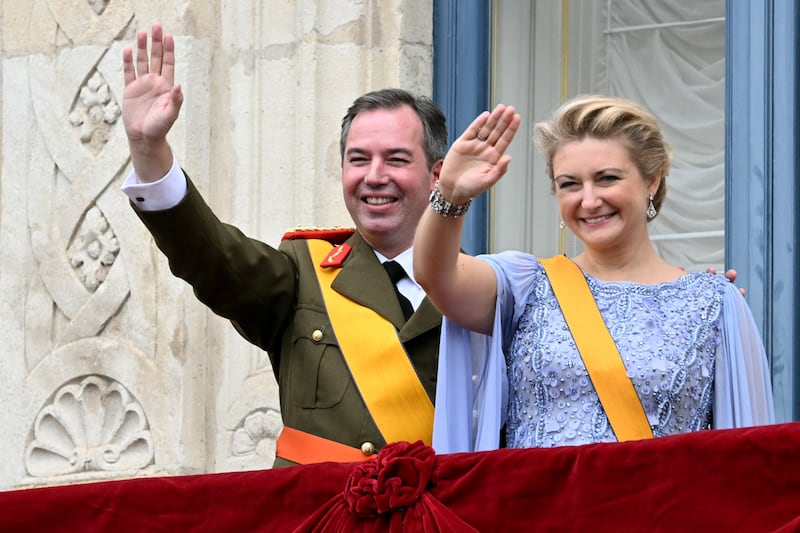 Luxembourg's Grand Duke Guillaume and Duchess Stephanie wave from the balcony of the Grand Ducal Palace after being sworn-in as Grand Duke Head of State and Duchess of Luxembourg in Luxembourg city on October 3, 2025. Luxembourg will enthrone a new sovereign today with Prince Guillaume set to succeed his father, Grand Duke Henri, who officially abdicates on the same day, ending a 25-year reign. (Photo by NICOLAS TUCAT / AFP) (Photo by NICOLAS TUCAT/AFP via Getty Images)