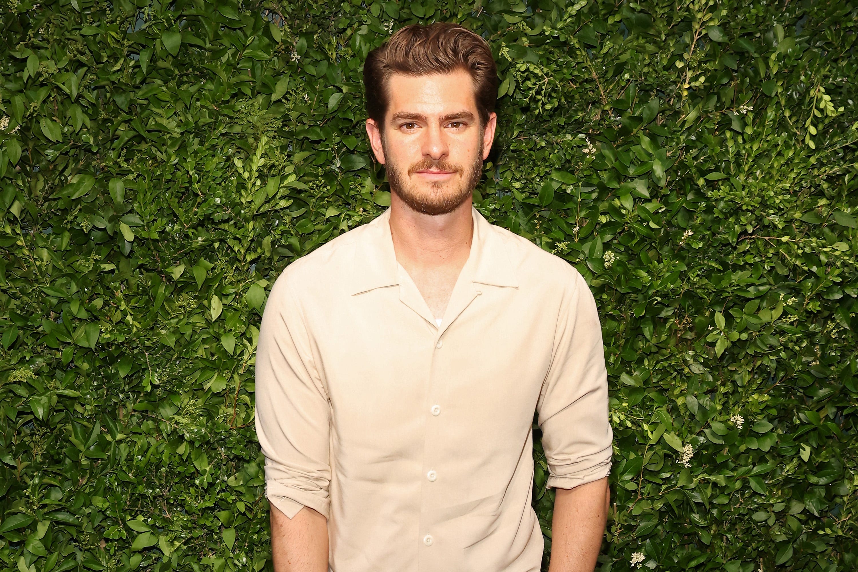 Andrew Garfield in a cream colored shirt