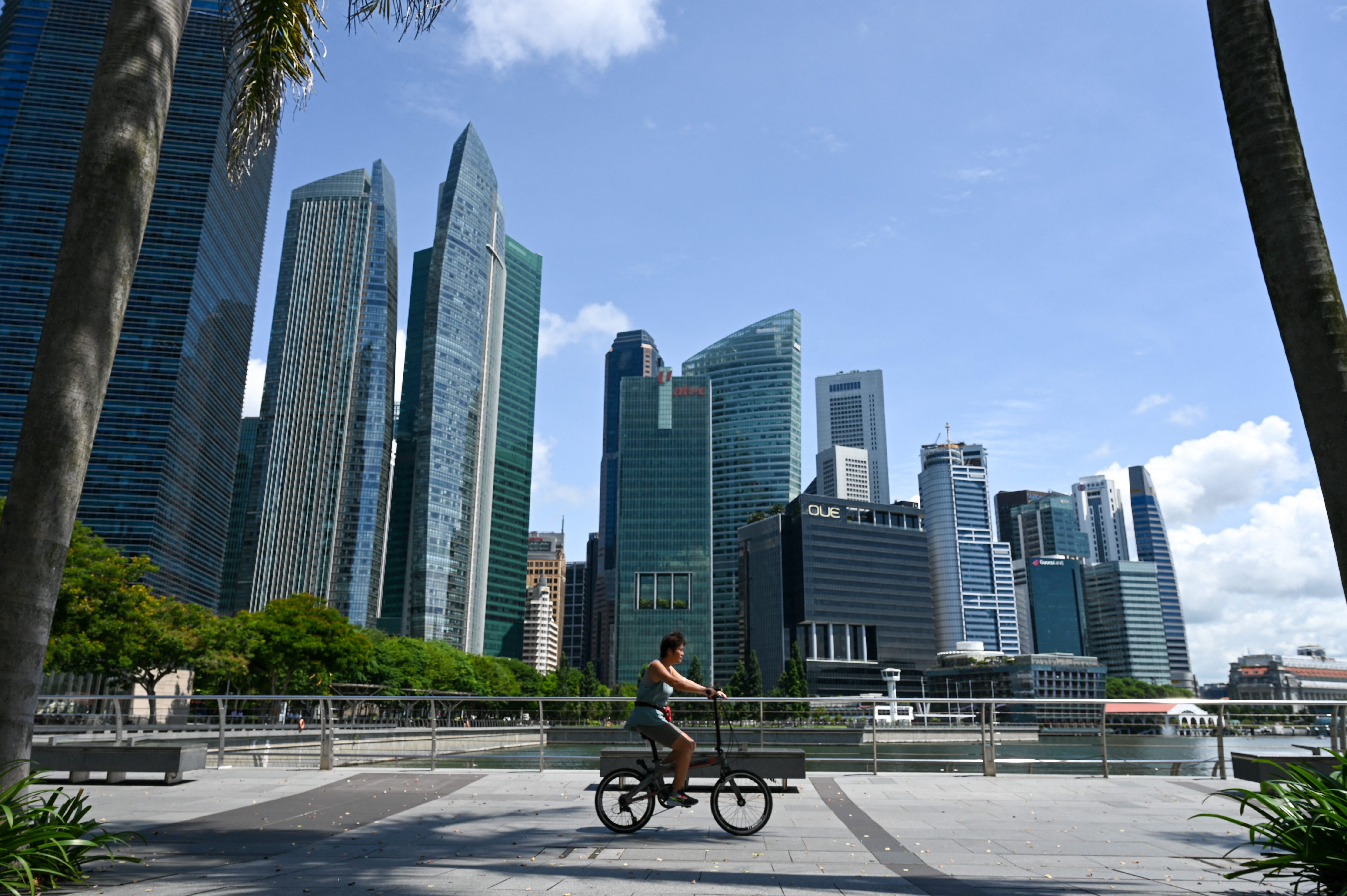 A cyclist rides along the Marina Bay promenade, which is next to the financial business district in Singapore on May 9, 2022.