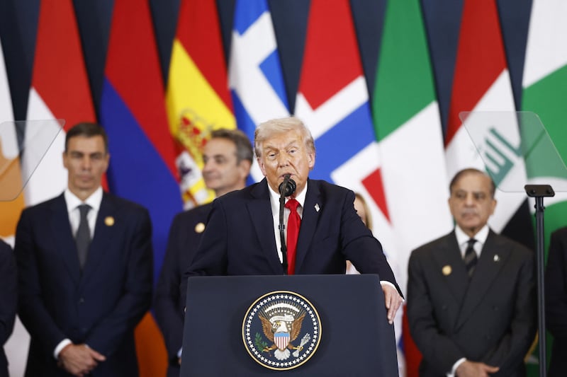 President Donald Trump delivers remarks statement during a summit on Gaza in Sharm el-Sheikh on October 13, 2025 with other world leaders standing behind him.