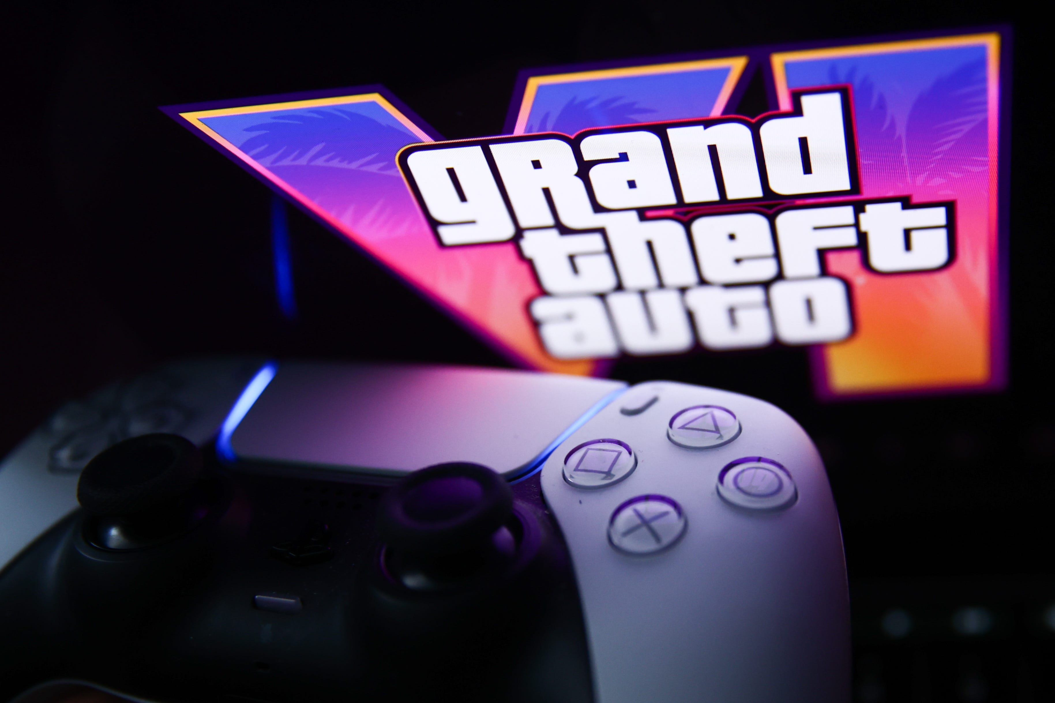 Grand Theft Auto 6 logo on a screen behind a PlayStation 5 controller