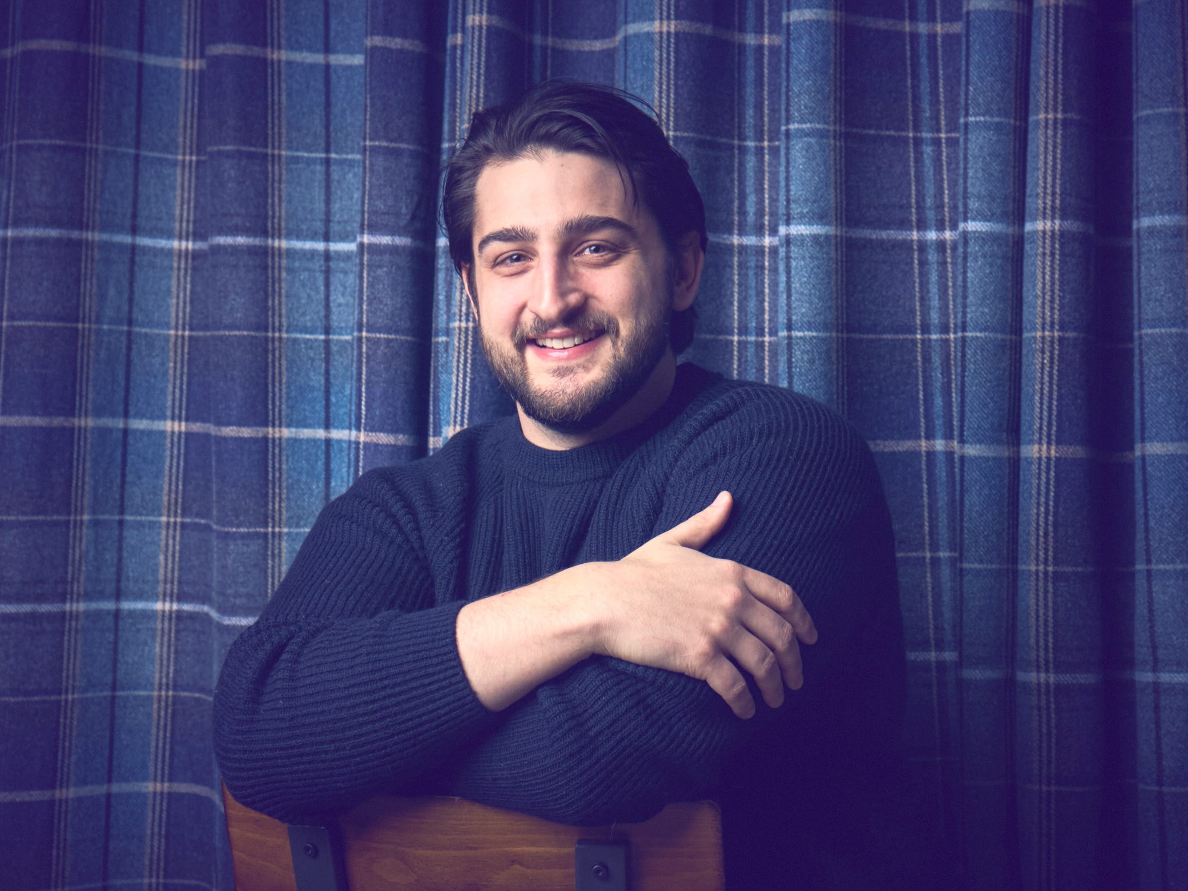 Yoni Rechtman smiles with his arms crossed