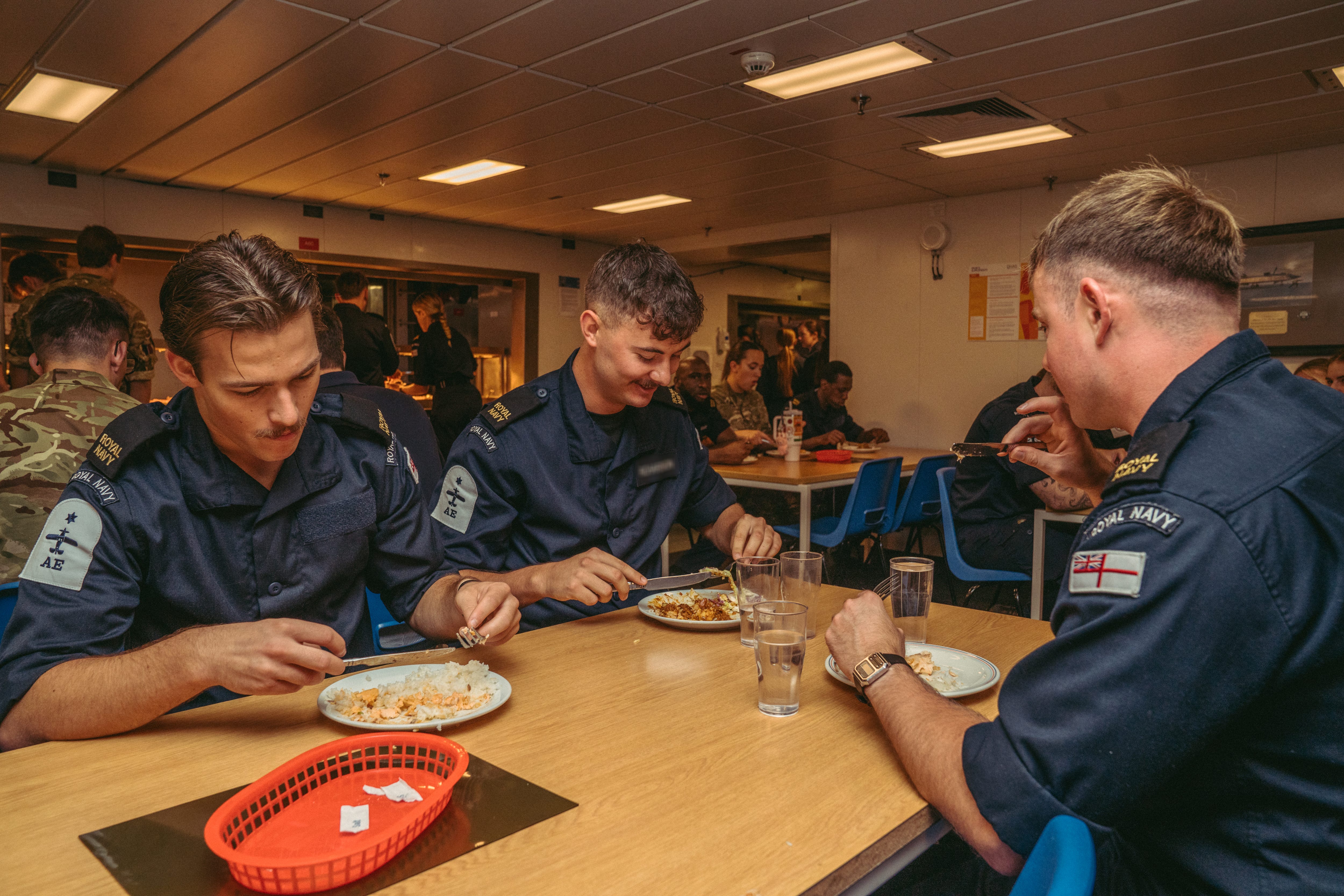 Royal Navy Sailors having lunch at the Junior Rates dining area.