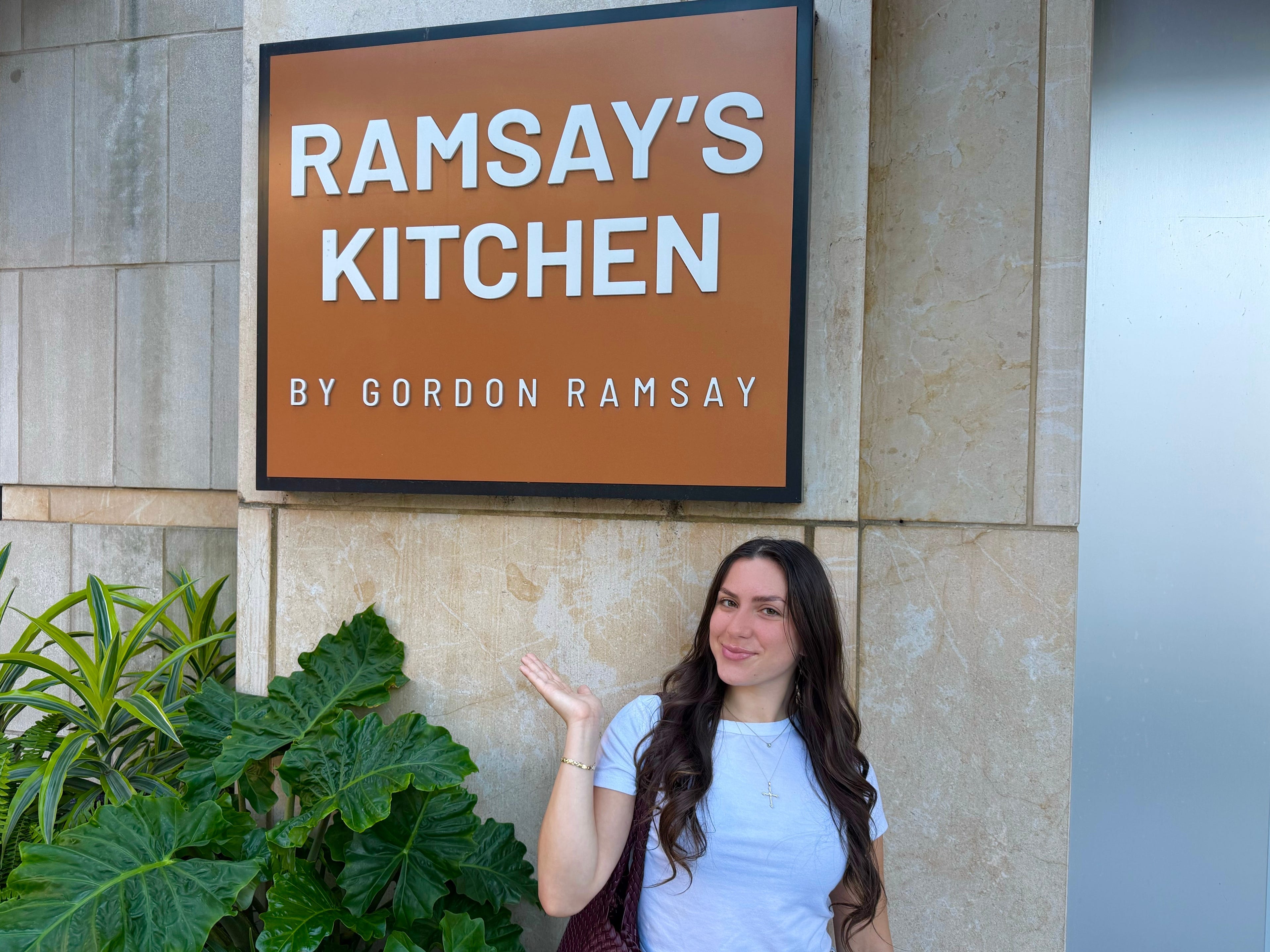 Amanda standing in front of a Ramsay Kitchen sign.