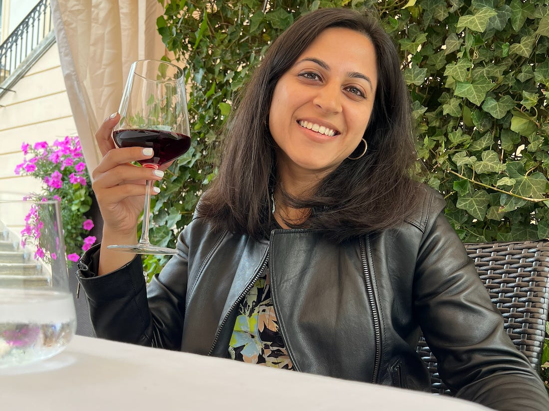 Sneha Saigal holding a glass of wine