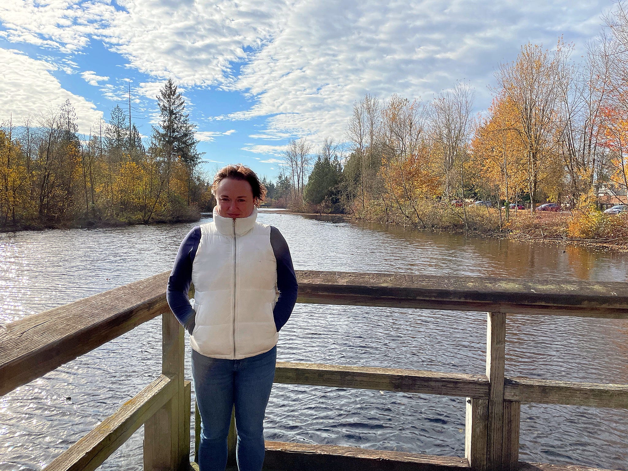 Author Heidi Turner in vest with hands in pocket at a park