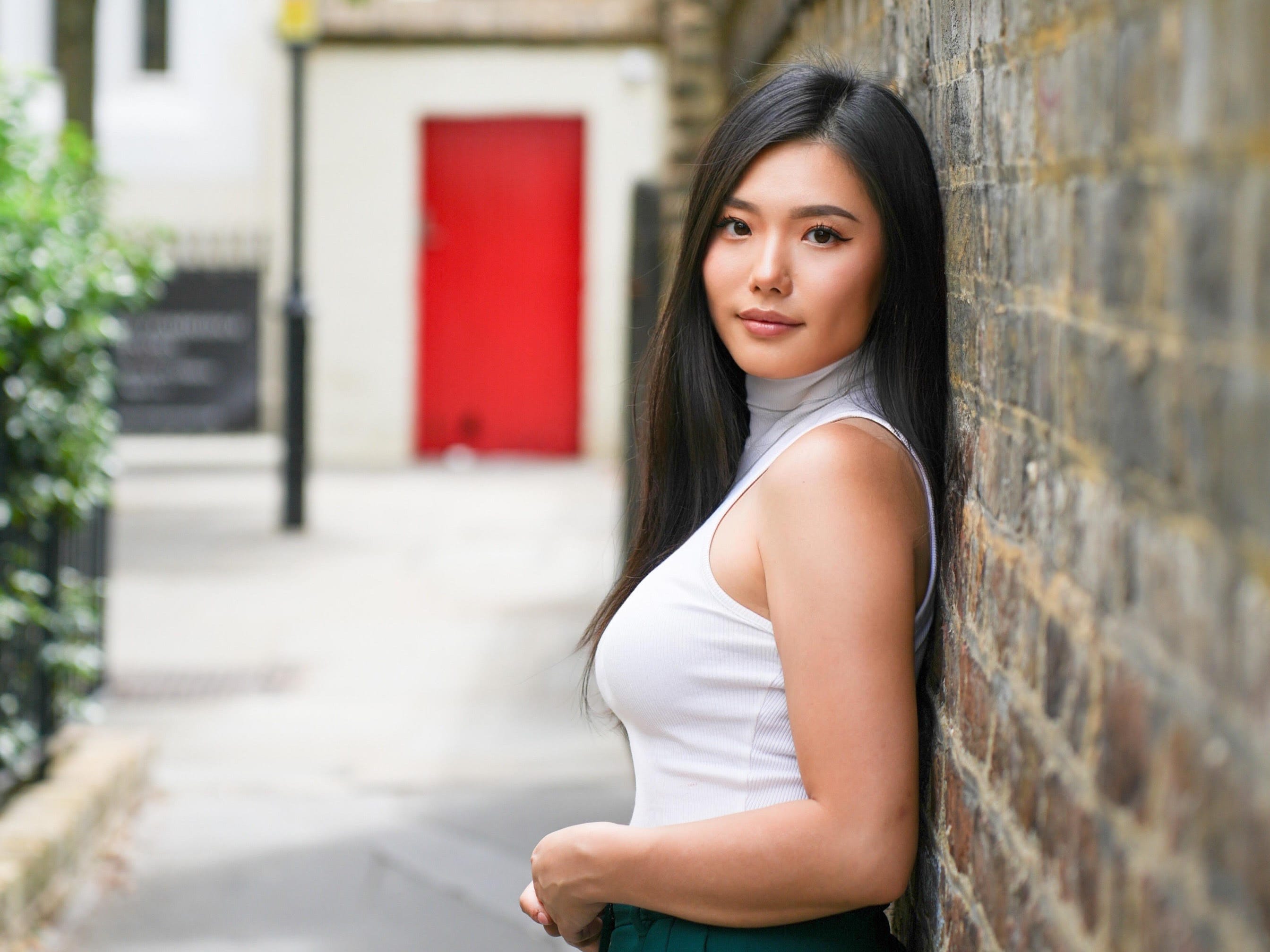 Photo of Aria Kim as she stands with her back against a wall