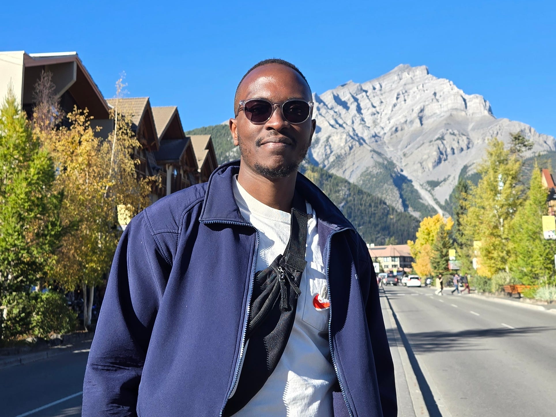 Mwangi Wanjau standing in front of a mountain in Alberta, Canada.