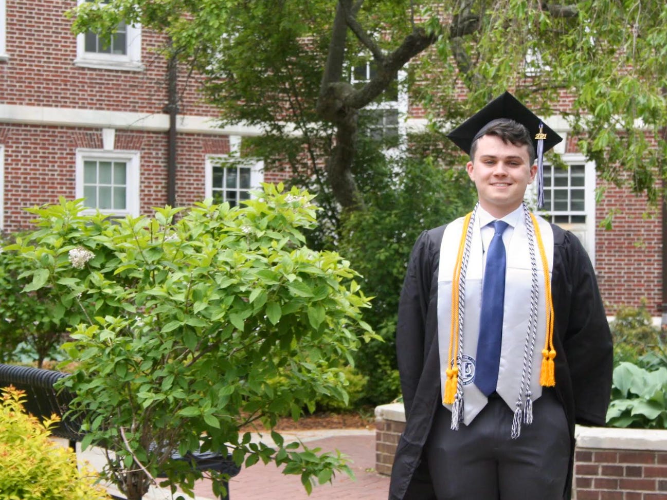 Teddy Rainville in cap and gown at college graduation