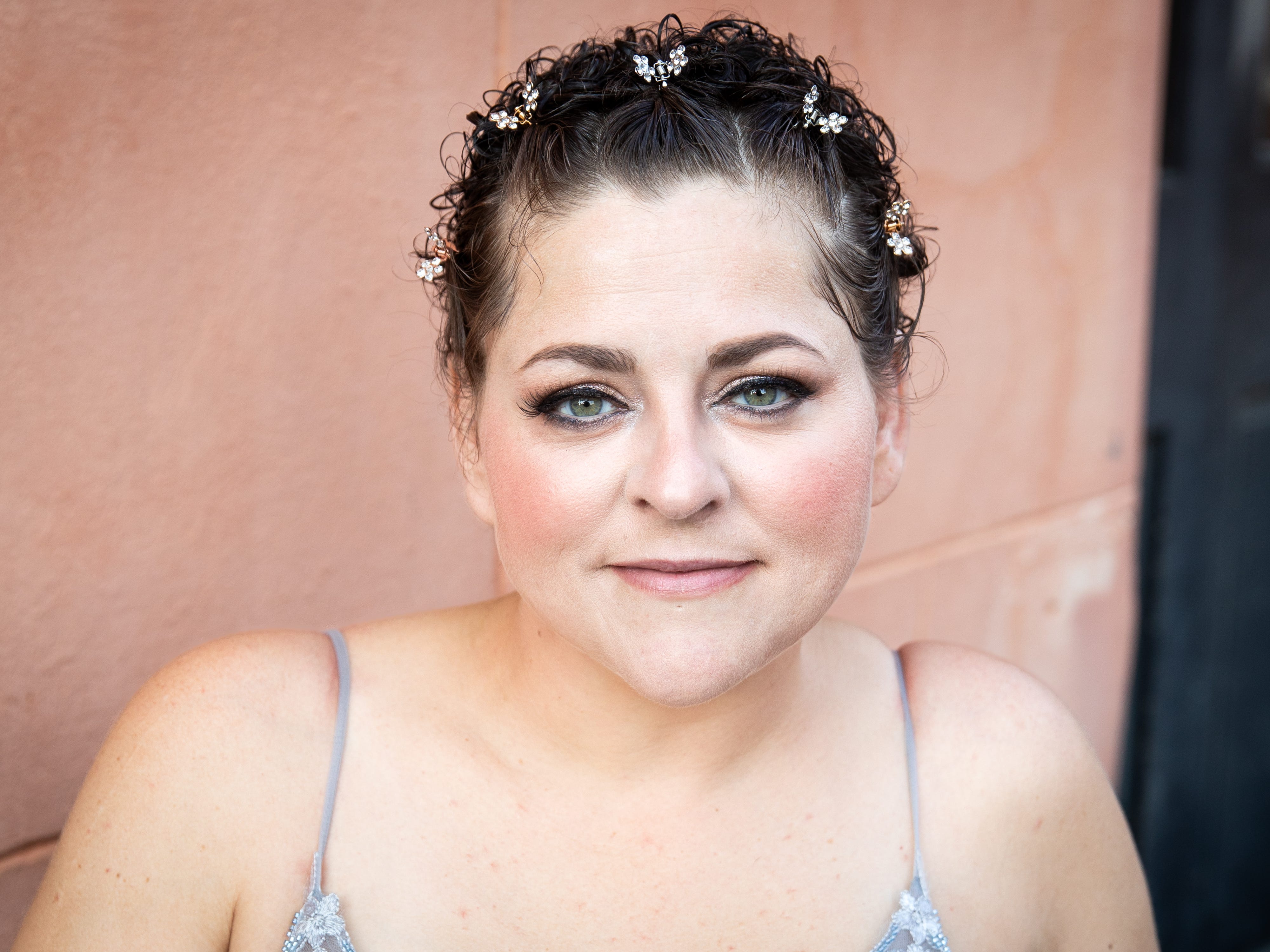 A woman in a strappy silver gown