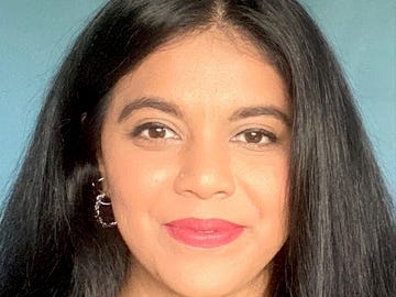 a headshot of a woman with black hair