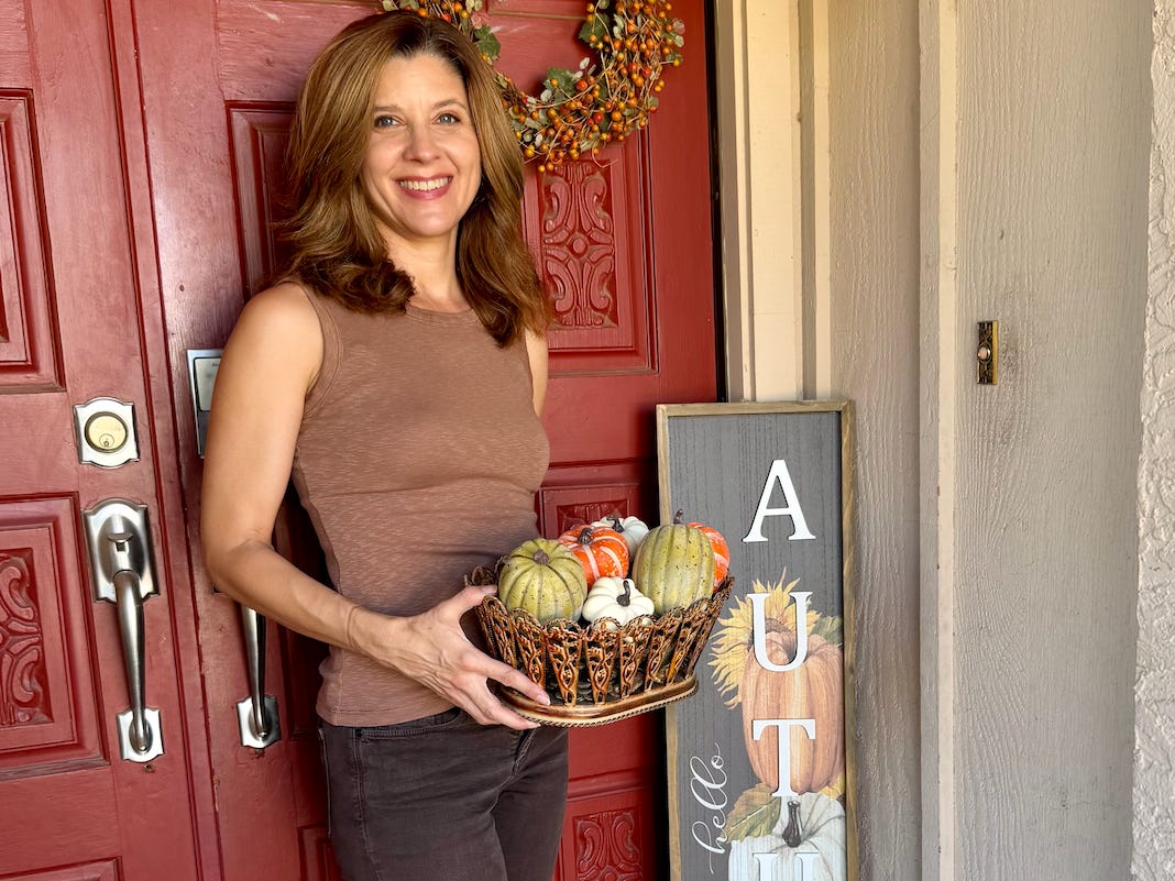 Woman posing by her door