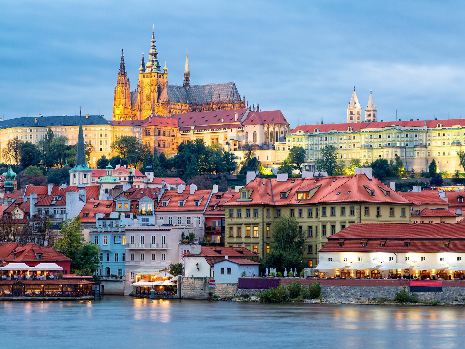 Buildings and a cathedral near the water in Prague.
