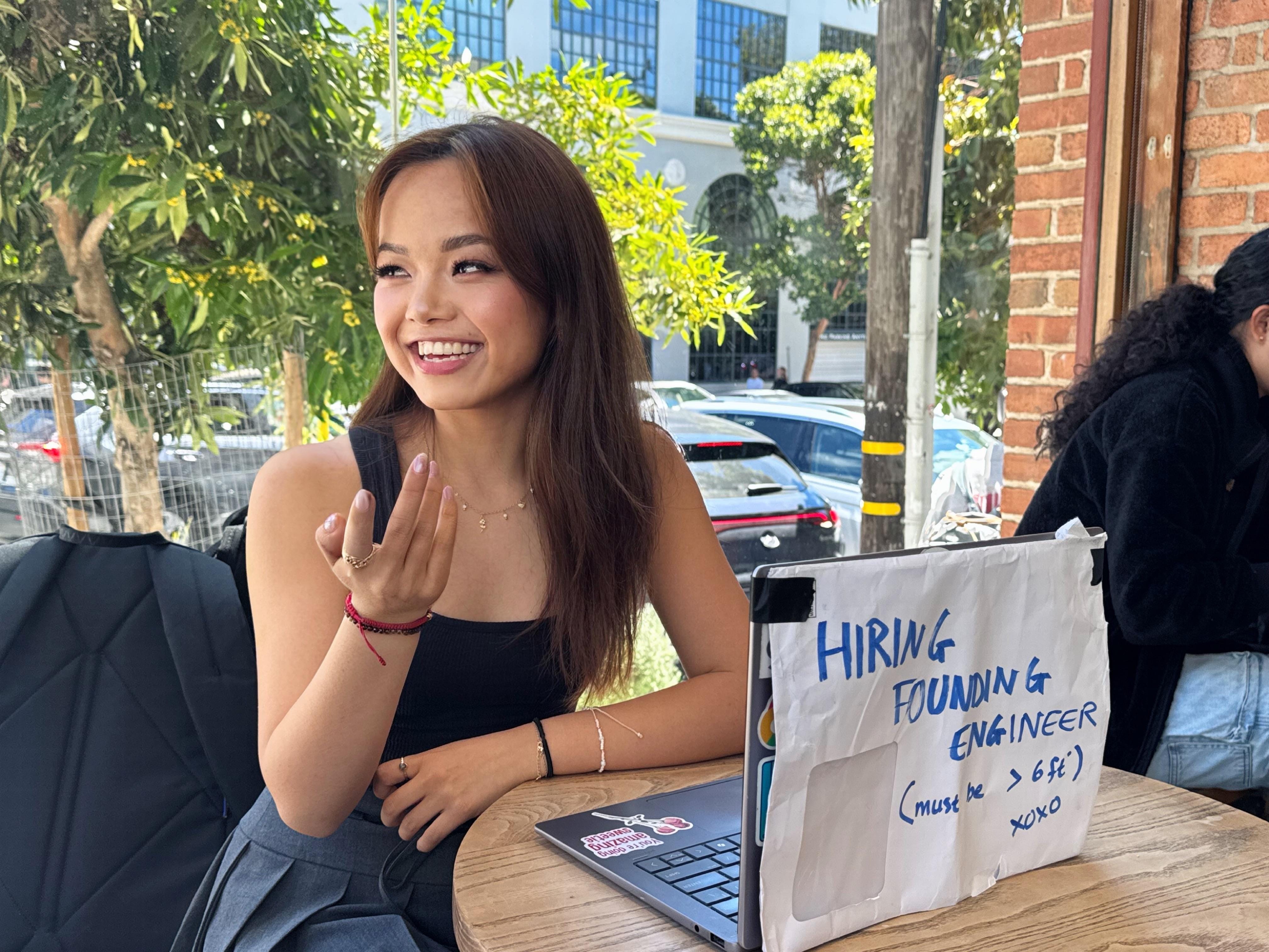 Annie Liao, Build Club founder, sitting with a laptop at a cafe.