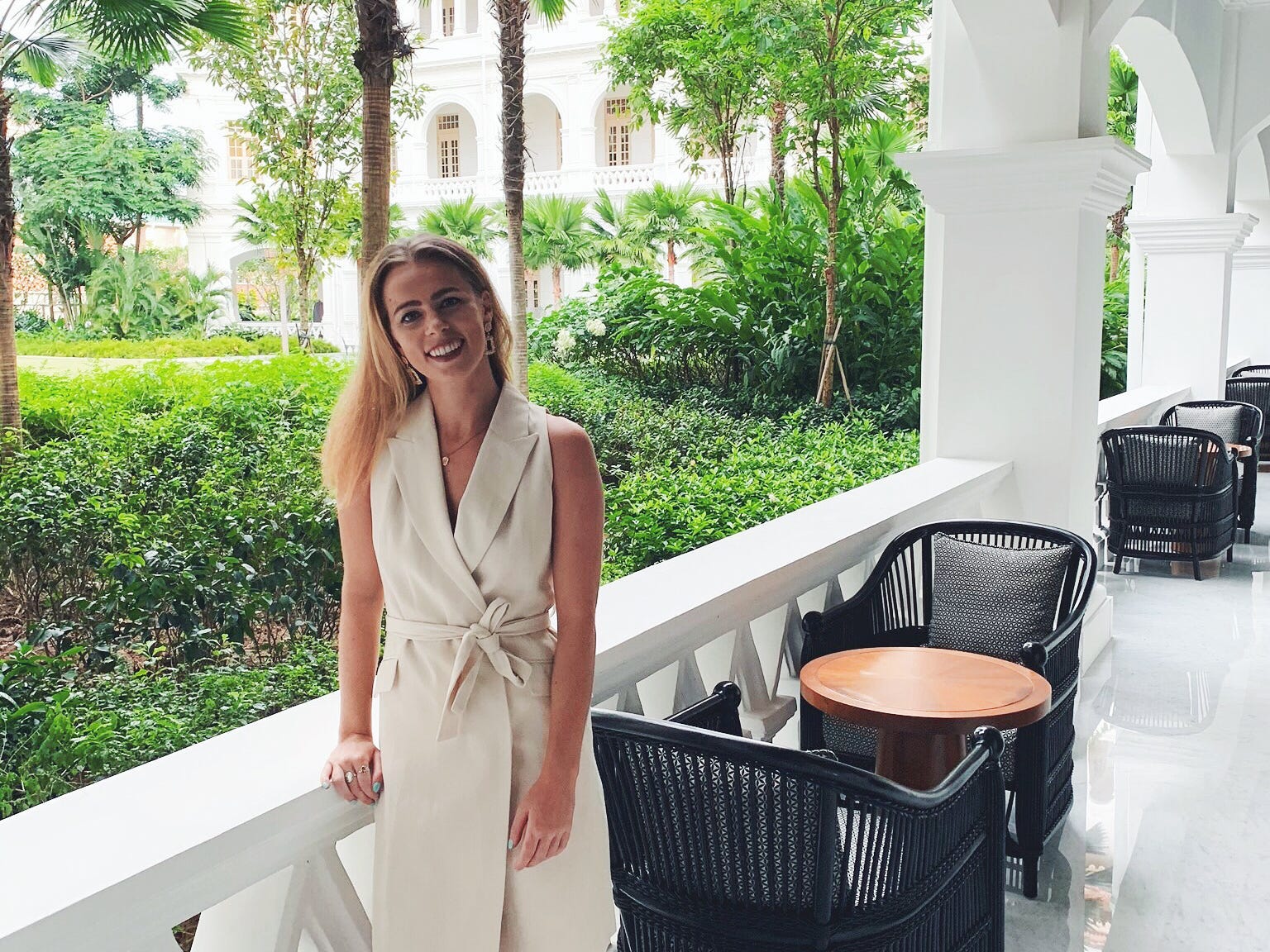 The author poses on a balcony.