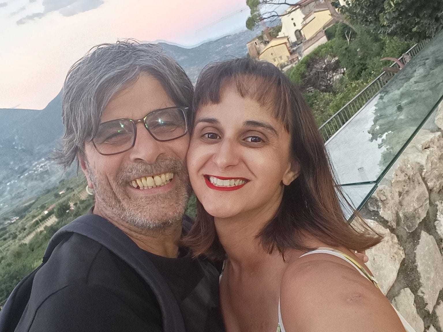 Caroline and her husband pose for a selfie at sunset.
