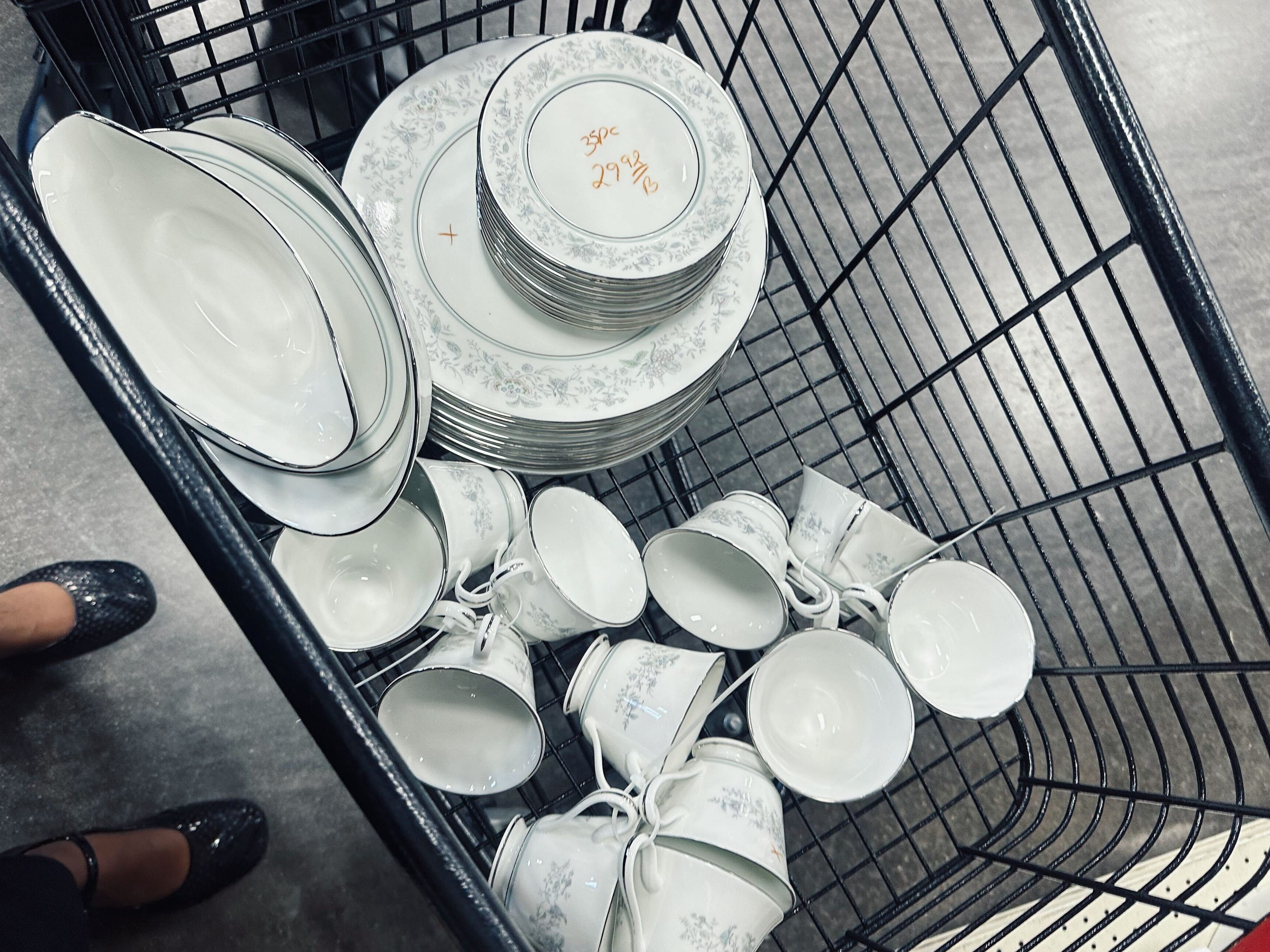 Dishware in a shopping cart.