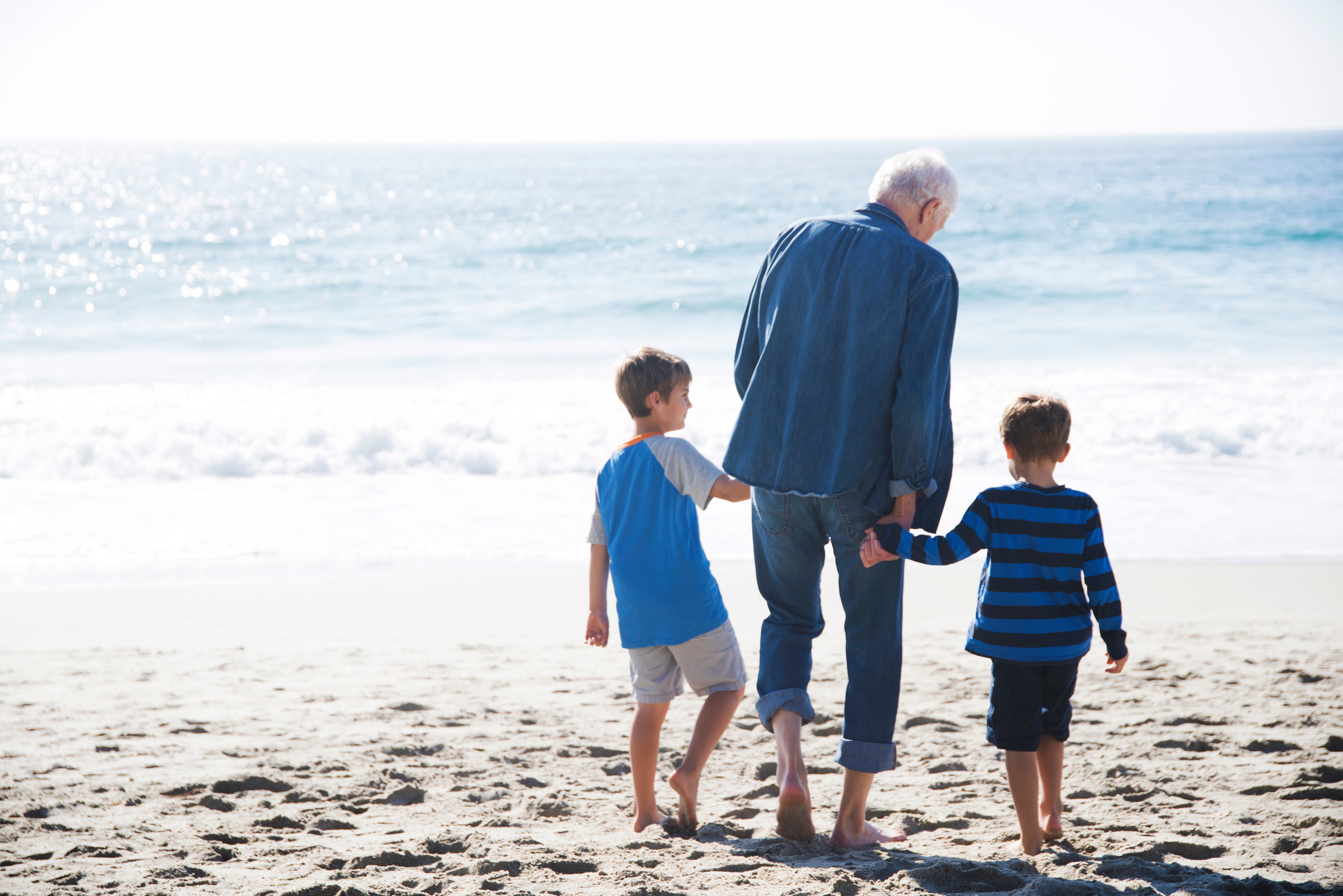 A granddad with his two grandchildren.